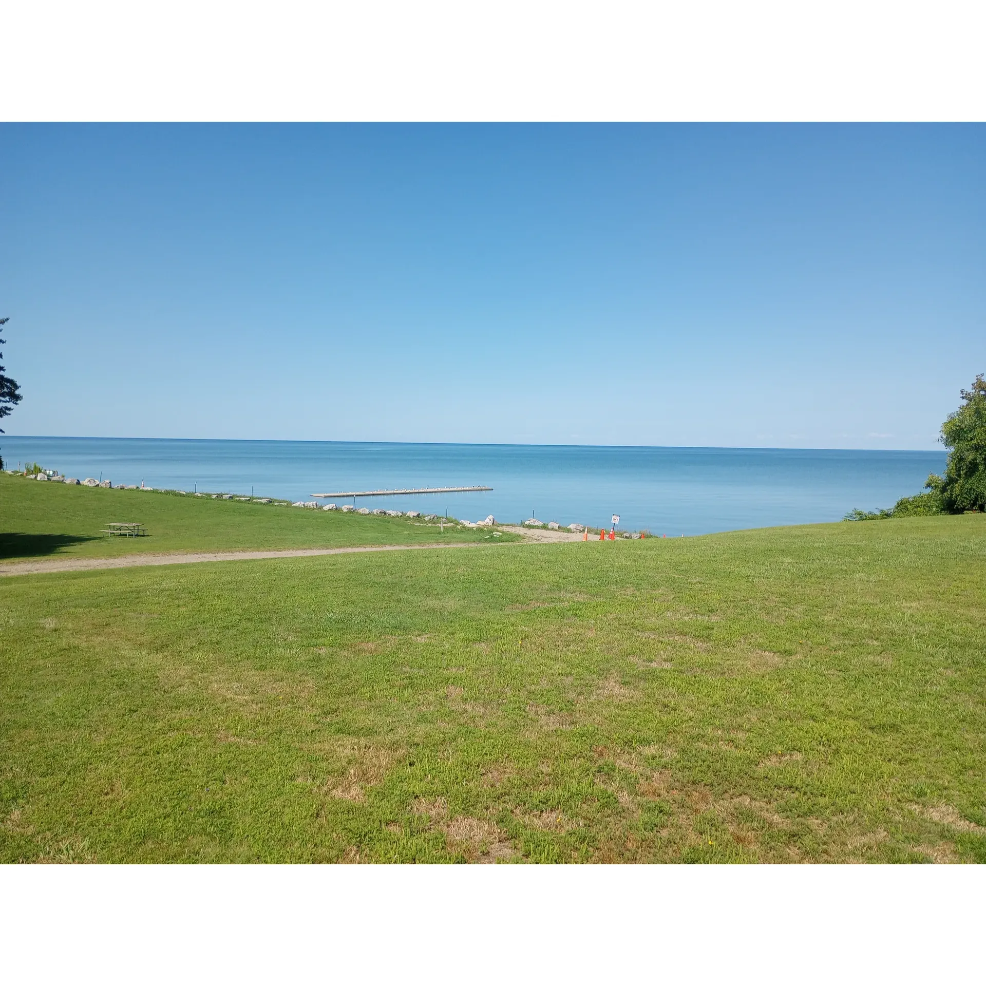 Lake Erie State Park is a breathtaking natural sanctuary offering visitors an unforgettable experience, with an affordable entry fee and ample parking to accommodate guests. Visitors are regularly treated to the awe-inspiring sight of sunsets over Lake Erie, creating memories that last a lifetime amidst the beautiful setting.

The park's pebbled beach provides a unique and beautiful landscape, where guests often engage in the serene pastime of pebble stacking. The beach is meticulously maintained, offering stretches of sand punctuated by naturally occurring wood logs that invite guests to sit and appreciate the stunning lake views.

For those who prioritize cleanliness and convenience, the park ensures that its facilities, such as porta-potties, are kept in pristine condition. It's also a haven for pet lovers, with a dog-friendly policy that allows for shared enjoyment between visitors and their furry companions.

Outdoor enthusiasts will find plenty of activities to fill their hours, including walking trails that reveal the beauty of the park and lake access that's ideal for kayaking. Playgrounds dotted throughout provide playful havens for younger visitors, making it a family-friendly destination.

The campground, renowned for its peaceful atmosphere, offers well-maintained amenities including restrooms, showers, and laundry areas. While providing the basics, it creates a vibe of simplicity and closeness to nature, which many find refreshing.

Visitors often return to the allure of Lake Erie State Park, drawn back by its tranquil beauty, well-appointed facilities, and the sheer joy of being immersed in nature. Whether seeking tranquil solitude or an active getaway, it stands as a cherished spot where the magnificence of lake sunsets and the harmony of untouched nature converge for an authentic outdoor experience. Description by ChatGPT.