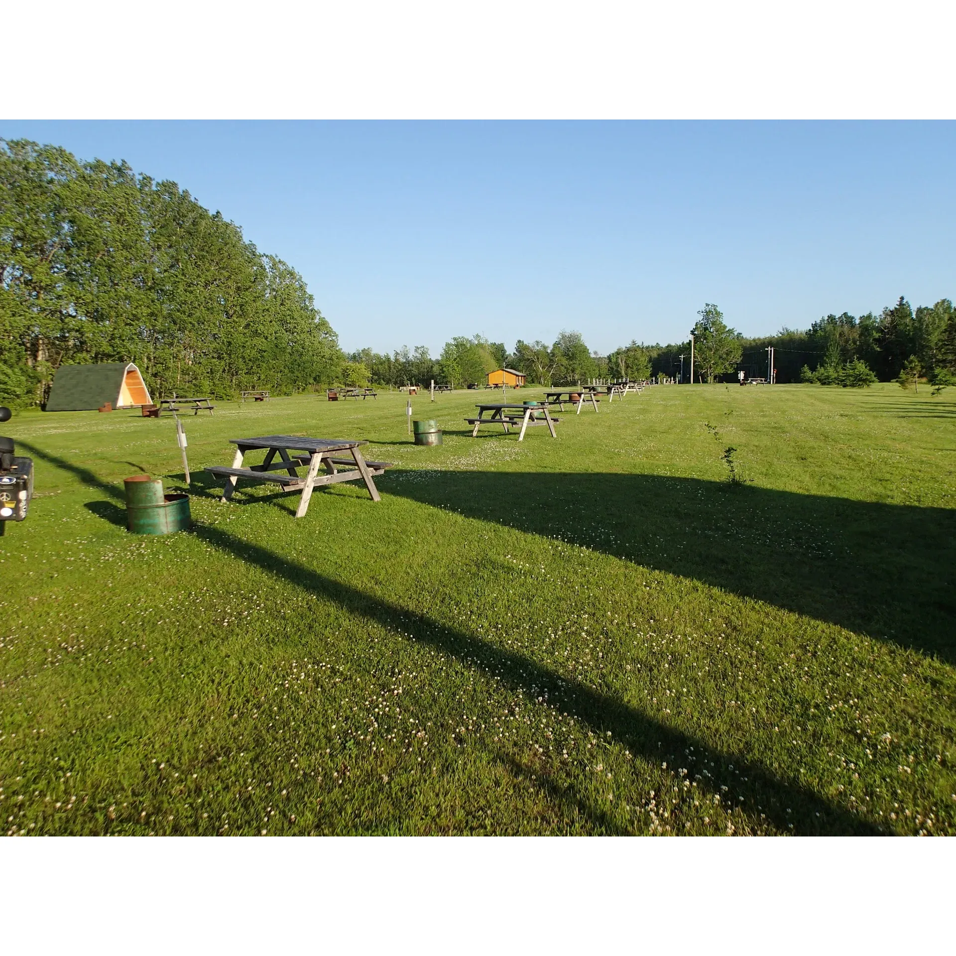 East Wallace Motorcycle Campground is an exceptional retreat specifically catering to motorcycle enthusiasts. Strategically located on the scenic Sunshine Trail, it's an indispensable stop for riders seeking an immersive outdoor experience coupled with the camaraderie of fellow motorcyclists. Owned and operated by the affable and hospitable Mark, whose first-class approach to hosting has been widely celebrated, this campground is equally perfect for a short pit-stop or an extended stay.

Accommodation options are ample and flexible; guests can pitch a tent on the beautifully maintained grounds, or opt for a cozy cabin if they've arrived without camping gear—a testament to the thoughtful amenities on offer. Pristine facilities add to the charm and convenience, ensuring that whether it's a leisurely shower or a need for a tidy rest area, comfort is always at hand.

The sense of community is palpable here; it's not uncommon to find Mark sharing his wealth of riding stories, dispensing invaluable travel advice, or simply ensuring that every guest feels at home. His passion for motorcycling and years of experience translate into a unique and authentic atmosphere that can only be found at East Wallace Motorcycle Campground.

With the availability of conveniences such as a fridge and BBQ, guests can enjoy the pleasures of outdoor living without forgoing the little luxuries. Even a simple pleasure like a well-brewed cup of morning coffee is given special attention, making each stay memorable.

Recommended with an A+ grade from its visitors, East Wallace Motorcycle Campground is more than just a place to stay—it's a special haven where the spirit of motorcycling adventure thrives, where every rider is sure to find a warm welcome, and where the journey's stories are just as important as the destination. Description by ChatGPT.