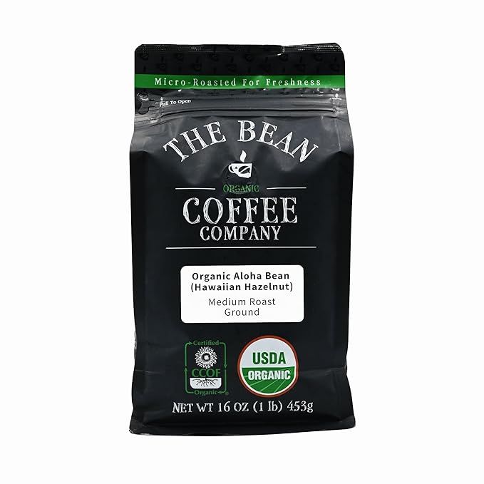 The Bean Organic Coffee Company's Aloha Bean is a medium roast, ground coffee that is infused with a sweet and nutty Hawaiian hazelnut flavor. This 16-ounce bag of organic coffee offers a smooth and delicious taste that is perfect for coffee lovers who enjoy a slightly sweet and aromatic blend.