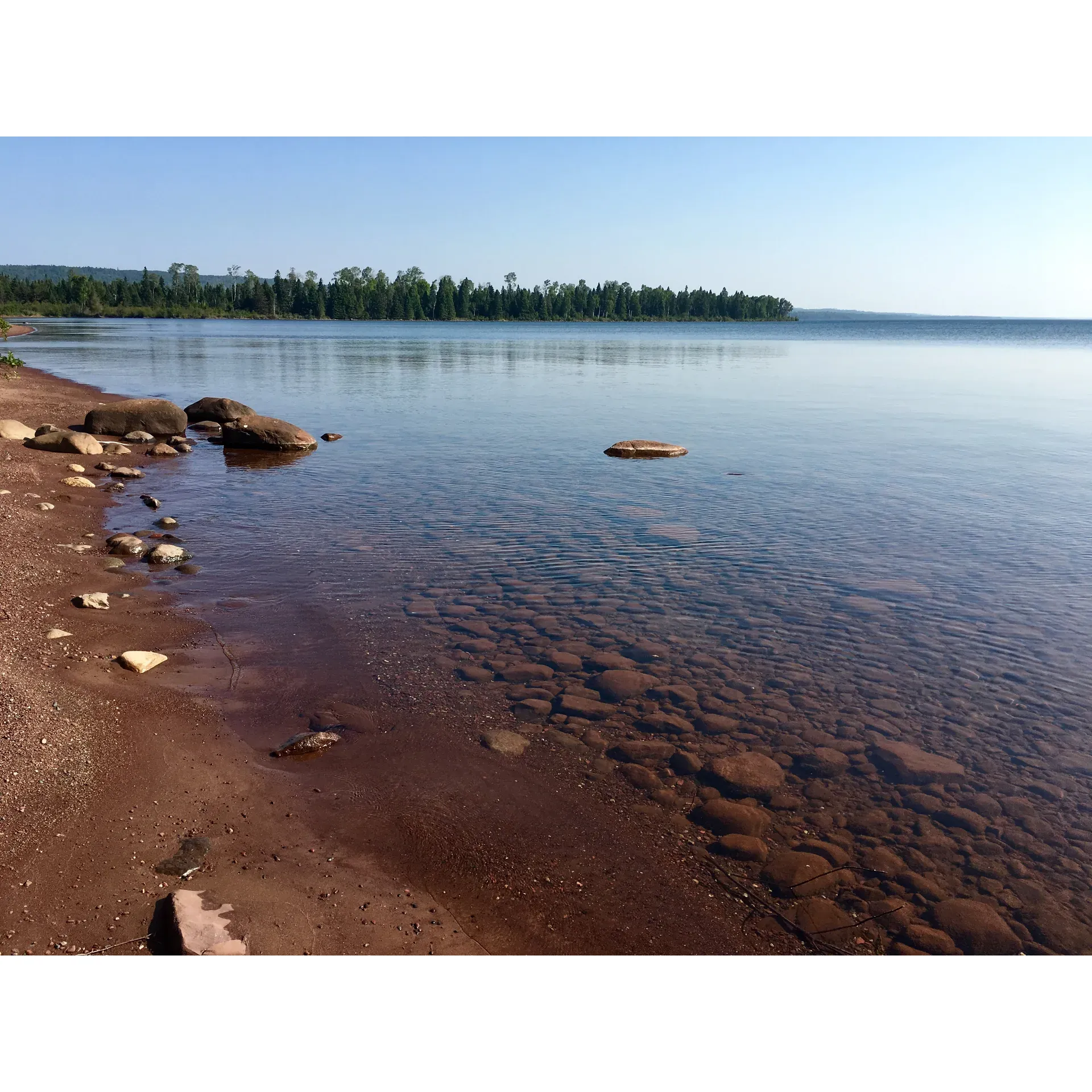 Siskiwit Bay Campground offers an enchanting escape for outdoor enthusiasts seeking a tranquil retreat by the expansive waters of Lake Superior. This idyllic destination captivates visitors with its serene beauty, making it the perfect spot for relaxation and leisure activities. An outdoor haven, the campground boasts a charming dock where guests are often found engrossed in their favorite books or engaging in friendly card games, enveloped by the soothing sounds of the lake.

Adventure-seekers and aquatic aficionados will revel in the invigorating experience of swimming in the refreshing, albeit brisk, waters of Lake Superior. For those who crave a more relaxing pace, the sandy beach offers a picturesque spot to idle away the hours, complete with a welcoming fireplace to enrich the ambiance. As the day gently transitions into night, the beach becomes an unrivaled stage for the spectacle of breathtaking sunsets painting the sky in vibrant hues.

Among the campgrounds dotting the landscape, Siskiwit Bay Campground stands out as a gem, earning high praise for its prime lakeside location and delightful swimming spots. Embraced by the natural splendor of the area, this campground is not just a place to stay; it is a gateway to experiencing the raw beauty of the bay and beyond. At Siskiwit Bay Campground, every moment spent is an invitation to unwind amidst the enchanting allure of nature's masterpiece. Description by ChatGPT.