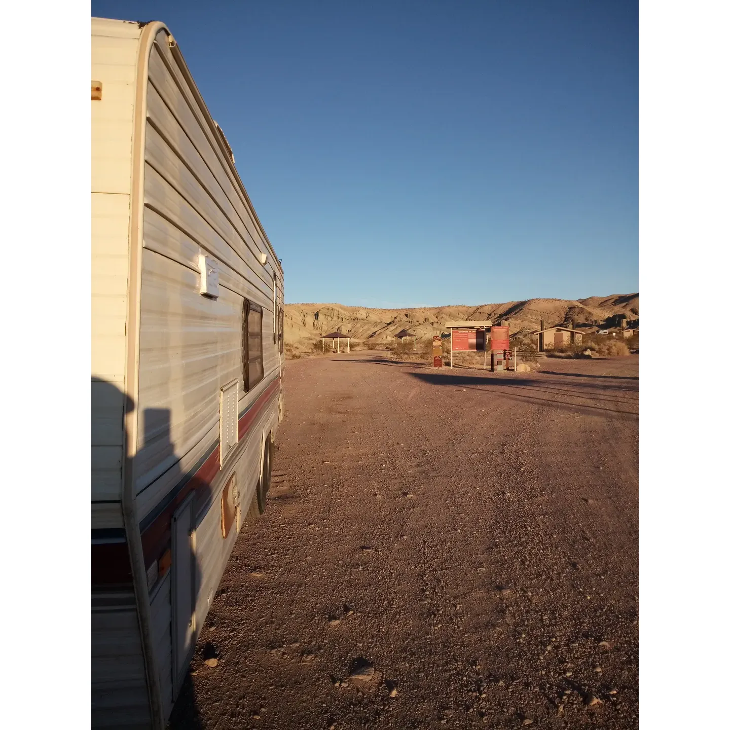 Owl Canyon Campground offers a picturesque retreat into the great outdoors with its affordable, serene, and scenic environment. Whether arriving by sedan, truck, or RV, guests are treated to a tranquil escape just a short drive from the main road. With praised accessibility and ample space, camping enthusiasts can find solace in this rugged, yet serene, BLM-managed site.

In the warm embrace of nature, Owl Canyon provides an array of amenities to enhance the camping experience. The campground features well-maintained pit toilets and individual sites equipped with picnic tables, ramadas for shade, and fire pits perfect for cozy evenings under the stars. In particular, guests can indulge in fantastic stargazing opportunities, thanks to the clear night skies free from the city lights.

Families and adventure-seekers alike will delight in the site's proximity to Rainbow Basin, known for its vibrant geological formations and fossil-rich landscapes. Kids, especially, will find joy in the simple pleasures of exploration and discovery amidst the natural playground. Additionally, the location is a treasure trove for hikers and those looking to immerse themselves in the unique geology of the area.

While the road leading to Owl Canyon Campground invites a sense of adventure with its unpaved, washboard character, the drive itself promises a rewarding destination. Upon arrival, visitors can set their wheels at ease and bask in the soothing ambiance, picturesque views, and a spectrum of warm hues painted by the setting sun.

Despite the absence of water on site, the campground makes up for it with its affordability and beautiful environment that provides a blissful, back-to-basics camping experience. The diligent presence of a ranger ensures that the area remains well-attended and pristine.

For anyone seeking an authentic outdoor experience teeming with natural beauty, tranquility, and opportunities for leisurely hikes and family-friendly fun, Owl Canyon Campground stands out as a highly recommended and memorable destination. Description by ChatGPT.