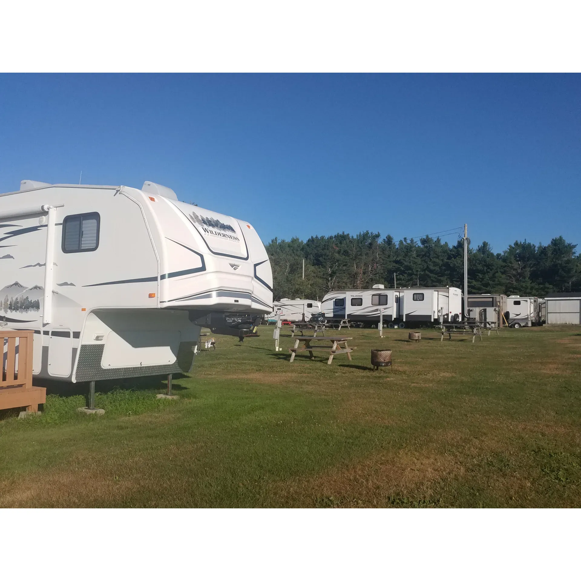 Sunrise Campground, beautifully perched overlooking the majestic Miramichi River, offers visitors a serene outdoor experience where clean and well-maintained premises set the stage for an idyllic camping retreat. With a warm, inviting atmosphere cultivated by friendly and accommodating owners, guests receive personal attention, ensuring a smooth and welcoming set-up at their chosen site.

The campground is praised for its tranquility and family-friendly environment, making it an ideal stopover for road trippers looking to break up their journey or a repeat destination for seasonal explorers. The appeal of Sunrise Campground is amplified by its unique features, such as the inviting warm saltwater pool and the enchanting, wooded sites that offer a cool respite from the sun.

Campers rave about the picturesque views from their spots right on the water and appreciate the cleanliness of the facilities, adding a level of comfort to the natural charm of the campground. Even the rustic bathrooms receive accolades for their immaculate condition, with convenient pay showers available.

Each visit at Sunrise Campground promises a canvas of natural beauty, a splash of leisure, and a sprinkle of camaraderie among guests, making every stay a recommendable and memorable escape. Whether you're passing through or making it a destination, this campground captures the heart of outdoor enthusiasts and leisure seekers alike. Description by ChatGPT.