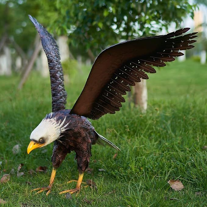 The Chisheen Bald Eagle Statue is a striking outdoor garden sculpture made of metal, perfect for adding a touch of patriotic elegance to your yard or garden. This large eagle figurine stands at an impressive height and is beautifully crafted with intricate details, capturing the majestic beauty of the bald eagle.