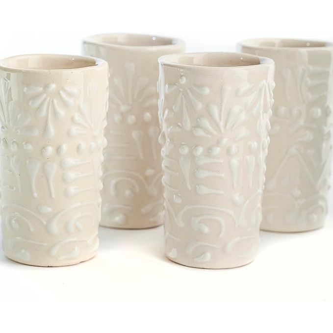 The Talavera Shot Glasses Set of 4 is a set of authentic Mexican tequila shot glasses that are hand-painted with a white lace design. Each shot glass has a capacity of 2 oz, making them perfect for serving tequila or other spirits.