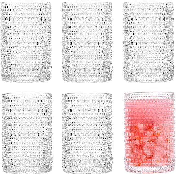 The Consou Large Glasses Set of 6 is a stylish and durable glassware set that includes six 15 oz glasses. These glasses are made from high-quality thick glass with a heavy base, making them sturdy and perfect for everyday use. The hobnail design adds a touch of elegance and sophistication to any table setting.