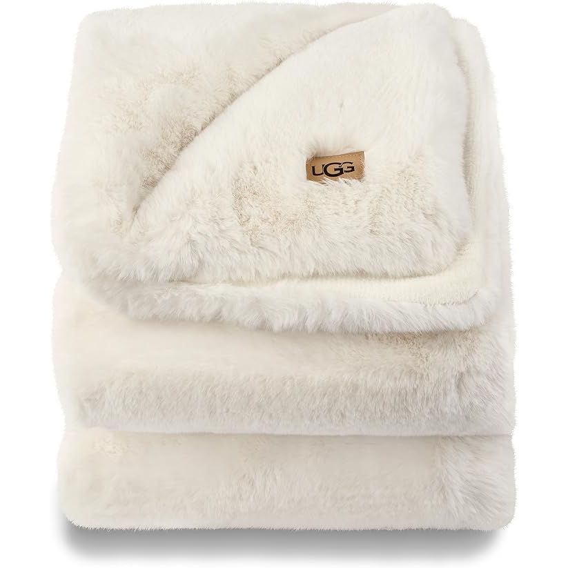 The UGG 16796 Euphoria Plush Faux Fur Reversible Throw Blanket is a luxurious and cozy addition to any couch or bed. This throw blanket is made with high-quality faux fur that is soft to the touch and provides warmth and comfort. It measures 70 x 50 inches, making it the perfect size for snuggling up on the sofa or keeping warm at night.