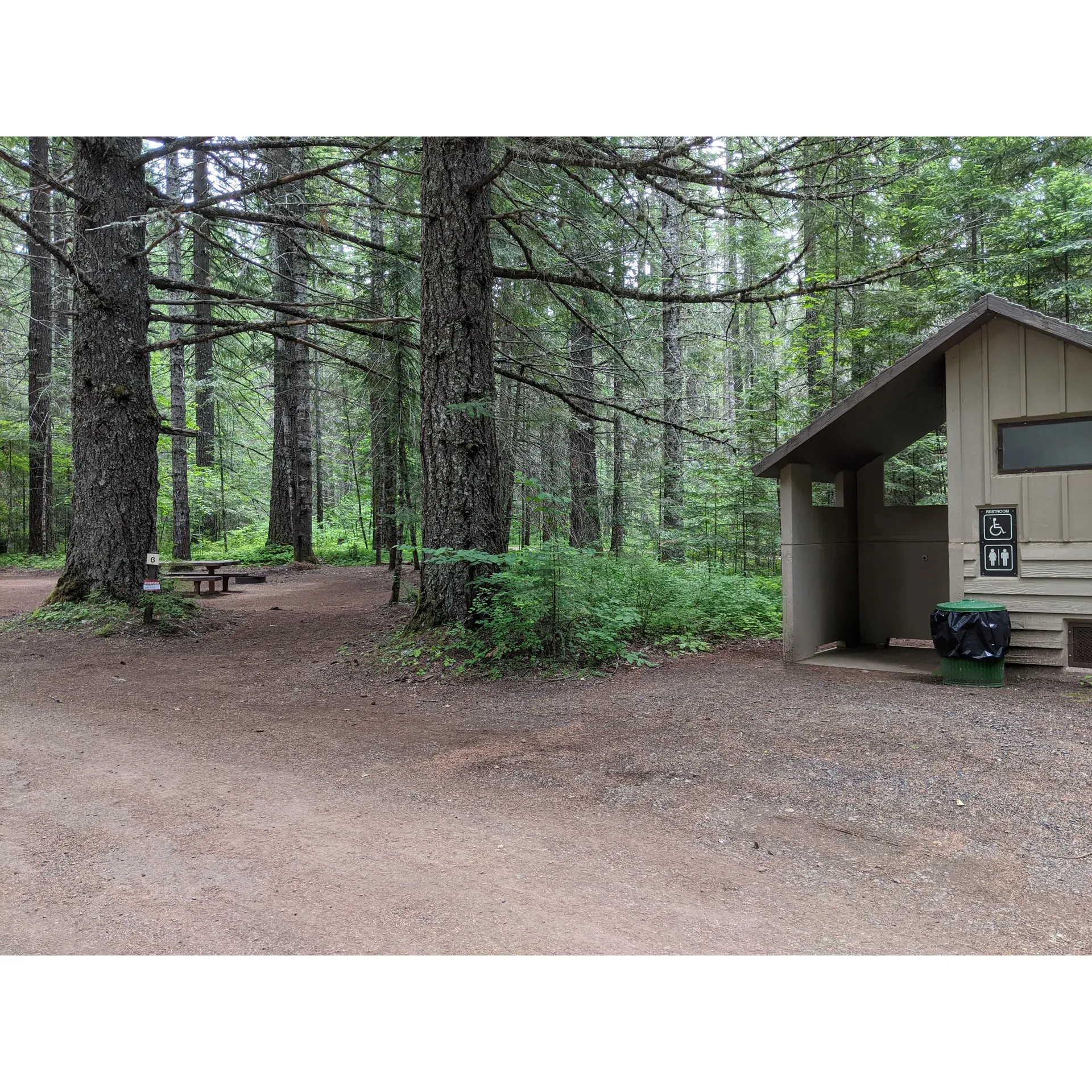 Experience the charm and tranquility of the serene Oklahoma Campground, a lush oasis tucked away within the majestic Gifford Pinchot National Forest. Boasting an array of well-maintained and spacious campsites, this is an ideal retreat for both solo adventurers and larger groups alike. Visitors can expect a range of site options, from cozy and small to expansive areas perfect for multiple tents, all thriving under a canopy of cooling shade provided by the plentiful trees—ideal for those warm, sunny days.

Cleanliness is a hallmark of this pristine campground, with spotless facilities and meticulously maintained vault toilets that set a remarkable standard of hygiene in natural settings. Thoughtful amenities include a convenient water pump dispensing refreshing and tasty water, ensuring guests are well-hydrated throughout their stay, and a neatly arranged dumpster at the campground's entrance for easy waste management.

The sites boast clear, flat land and are framed by lush greenery, offering an abundance of privacy and a sense of seclusion. Specific sites provide quick access to the serene waters of the Little White Salmon River, an inviting spot for a gentle splash or relaxing by the gently lapping creekside. The surroundings are a haven for quiet moments and nature exploration, with local wildlife and flora adding to the rich outdoor experience.

Affordably priced at $12 a night, this enchanting campground offers unparalleled value, with several meticulously maintained bathrooms and essential comforts amidst the forest splendor. While the site lacks a dedicated host within the grounds, the diligence and pride of the nearby off-site hosts are evident in the campground's exceptional upkeep and attention to detail.

The beauty of the Oklahoma Campground is enhanced by its readily accessible seclusion, with most sites thoughtfully designed to maintain an intimate atmosphere regardless of proximity to neighbors. Selected sites provide the perfect arrangement for group gatherings, while others cater to those seeking a more solitary escape.

As a gem in the midst of the great outdoors, Oklahoma Campground is the perfect setting for an idyllic getaway, offering an opportunity to disconnect and bask in the peaceful ambiance of nature. Whether seeking adventure or rest, guests leave with fond memories and an eager desire to return to this delightful sanctuary. Description by ChatGPT.