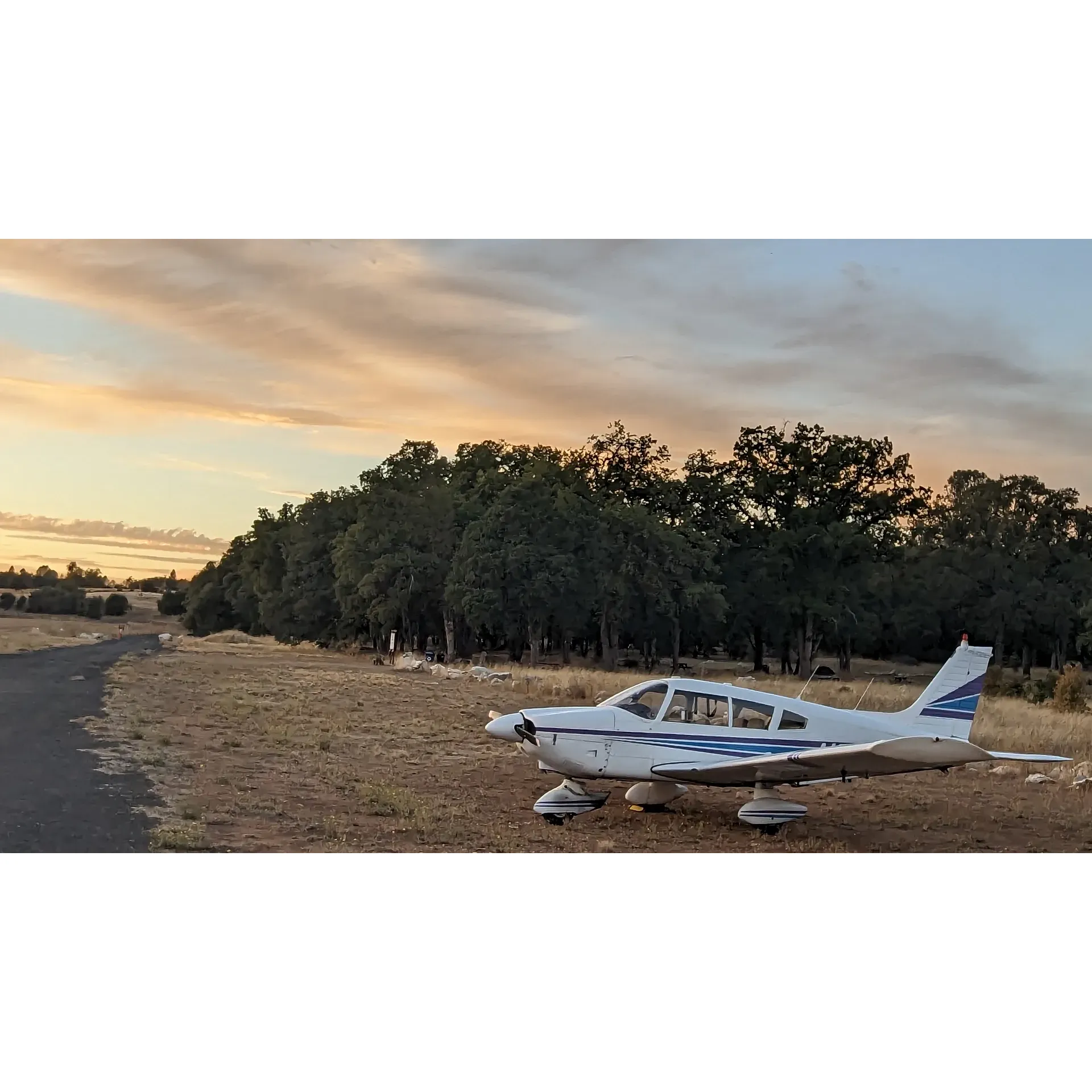 Set amidst the aviation bustle of Columbia, CA, the Columbia Airport Campground offers a unique outdoor retreat for flying enthusiasts and nature lovers alike. Visitors can enjoy the convenience of modern amenities, including well-maintained men's and women's bathrooms equipped with showers that provide ample hot water for a refreshing end to a day full of adventure. A quaint dining hall graced with a commercial kitchen is at the ready for hosting gatherings, and abundant picnic tables offer spots to dine al fresco under the open sky.

Those flying in will appreciate the ample airplane parking on a gravel and broken asphalt taxiway, ensuring your aircraft is just a short stroll from the camping area. With RV hookups available, the campground caters to both the traditional camper and those who bring their home on wheels. For leisure times, the campground is shaded with trees perfect for setting up a hammock to relax or trying your hand at the few disc golf holes within the site.

The campground's proximity to the heart of Columbia means guests are moments away from a variety of local culinary delights. Whether you're craving classic diner fare, authentic Mexican cuisine, or a slice of homemade pie from a local bakery, the town's diverse eateries promise to satisfy any palate. 

Experience the best of both worlds – the rustic charm of camping and the thrills of aviation – all within walking distance to both nature and nourishment at Columbia Airport Campground. Description by ChatGPT.