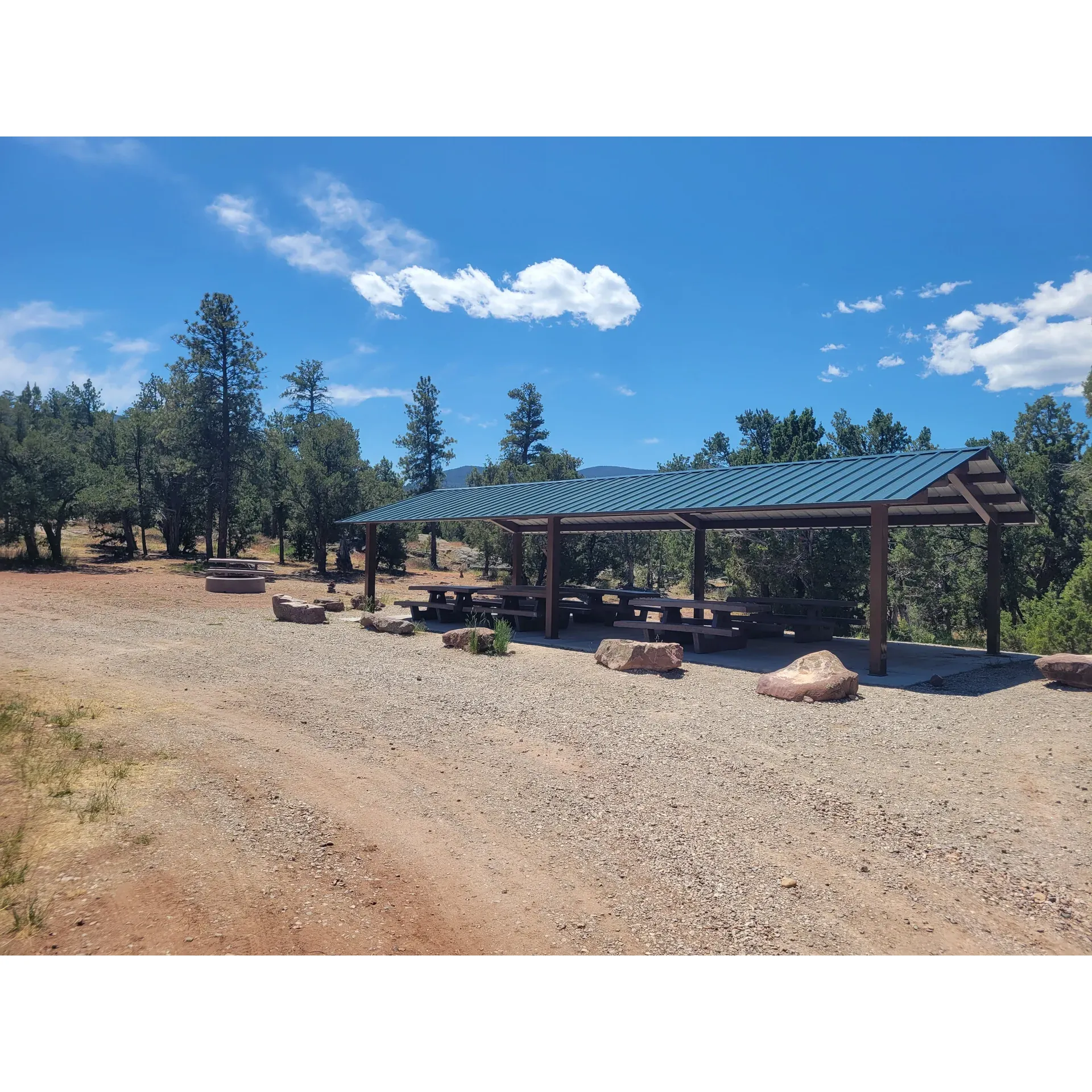 Arch Dam Group Campground is a prime outdoor retreat, ideal for large gatherings seeking to immerse themselves in the beauty of a natural setting. Campers can enjoy the convenience of having clean bathrooms and a reliable water spigot in the vicinity, ensuring refreshment and comfort throughout their stay. The area around the group sites is graced with new picnic tables and big fire pits, creating the perfect ambiance for socializing and evening campfires.

One of the campground's most celebrated features is the abundant shade provided by the surrounding trees, offering respite from the sun and creating a serene environment. Those interested in aquatic activities will appreciate the campground's close proximity to the dam boat launch, as well as the opportunity for a short drive to fish the river below the dam.

Easy accessibility from the adjacent paved road adds to the convenience, while the campground's reservation-only system contributes to its well-maintained appearance and the sense of exclusivity for visitors. Wildlife enthusiasts will enjoy observing the variety of lizards and occasional sightings of snakes, drawing nature lovers to its somewhat undisturbed habitat.

Notably, the Arch Dam Group Campground is continuously improving, with work underway to introduce amenities such as electricity to enhance the camping experience. Whether seeking a lively group event or a peaceful outdoor escape, this campground offers the necessary facilities and a picturesque setting just a stone's throw away from the vibrant Dutch John community. Description by ChatGPT.