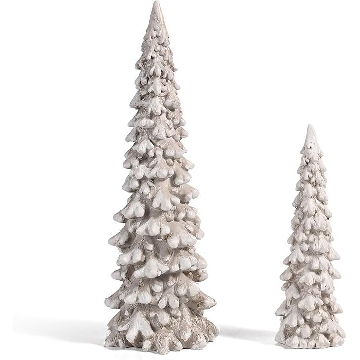 The RM ROOMERS 2Pcs Resin Christmas Tree Statues are a set of small white Christmas decorative figurines designed to add a festive touch to your home or office space. Each figurine features a detailed design of a Christmas tree made of resin material, giving it a durable and long-lasting quality.