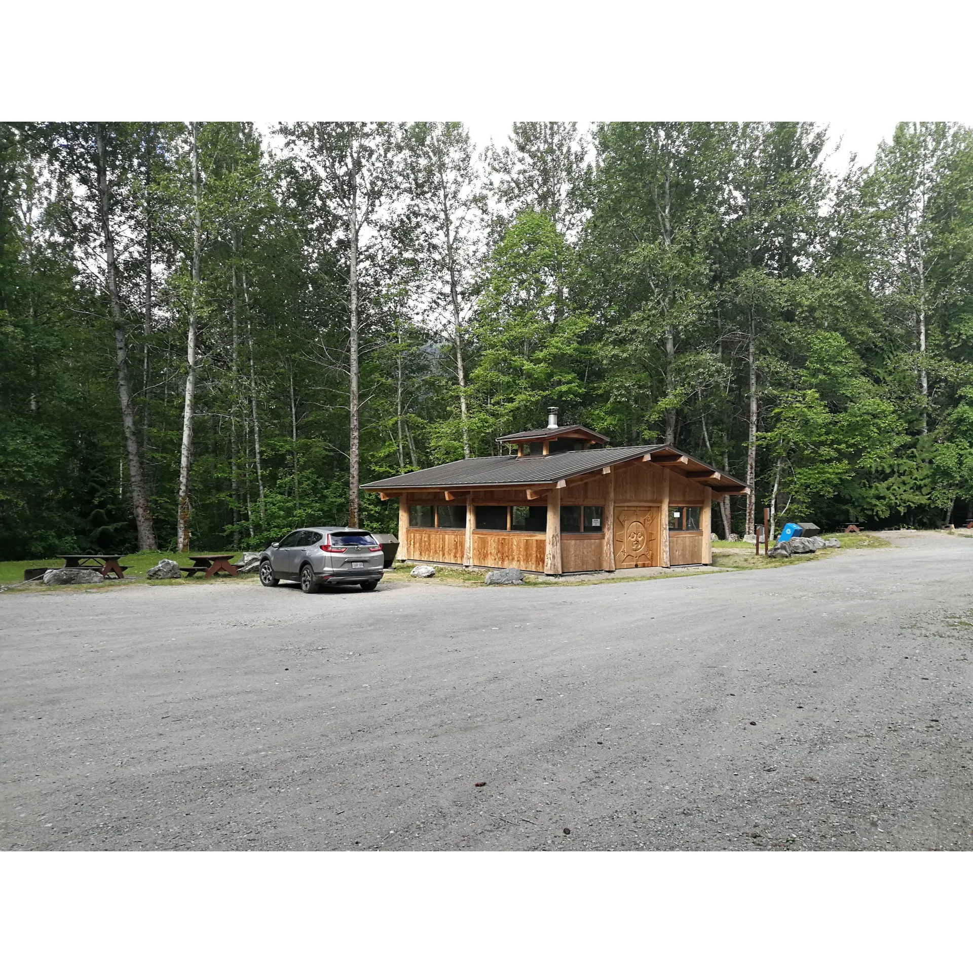 Tweedsmuir (South) Provincial Park - Fisheries Pool Campground offers outdoor enthusiasts a serene and picturesque camping environment with the added excitement of wildlife viewing opportunities. This splendid campground boasts an array of uniquely carved doors on its picnic shelter, showcasing the expert craftsmanship of Nuxalk Master Carver Qwaxwqwaxwanm Alvin Mack. With an accommodating setup for up to 9 hard-sided units and a pair of designated tenting pads located on an elevated bench, the campground provides ample choices for your stay.

Surrounded by the natural beauty of the park, visitors will find the RV sites thoughtfully arranged, though situated closely to foster a sense of community among campers. The tent sites, while limited due to wildlife considerations, offer a secluded retreat for those who prefer more traditional camping experiences. For tent camping alternatives beyond peak bear seasons, nearby Hagensborg presents additional options.

Hygiene is conveniently managed with well-maintained pit toilets, ensuring a comfortable and clean outdoor experience. Affordably priced at only $20 per night, the campground represents exceptional value for visitors seeking to immerse themselves in nature without compromising on budget.

Strategically located at one entrance of the Eskers/Smoke pit trail, campers have direct access to explore the surrounding landscapes. The campground also features a delightful riverside area, perfect for those hoping to catch a glimpse of bears in their natural habitat, with peak viewing from September 1 to October 15.

Despite its rocky terrain, the campground's charm and the array of available outdoor activities make this destination a favored spot for both adventure and relaxation amidst the awe-inspiring wilderness of Tweedsmuir (South) Provincial Park. Description by ChatGPT.