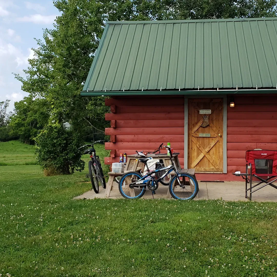 Hutchinson Family Farms offers an idyllic escape for outdoor enthusiasts seeking tranquility and adventure rolled into one. The farm is well-loved by visitors for its picturesque landscape and the warm hospitality extended by Dixie and Tim, the accommodating hosts. It's a haven for those who enjoy the melody of nature's quiet, coupled with opportunities for excitement and exploration.

A standout feature for many guests is the convenient access to the nearby river, complete with a canoe landing right at the campsite. For those eager to take to the water, Hutchinson Family Farms provides not only canoe and kayak rentals but also a seasonal shuttle service, giving adventurers the choice of a 2, 4, or 6-hour float to savor the scenic river routes. Thrill-seekers and nature photographers alike cherish the natural beauty of the river and its surroundings, capturing stunning photos that echo the peaceful essence of the grounds.

On-site amenities cater to comfort and convenience, offering a sense of ease to your outdoor experience. Guests appreciate the availability of restroom facilities and showers, ensuring that even amid the embrace of wilderness, modern conveniences are close at hand. Moreover, the farm's dog-friendly policy is a joy for pet owners who can share their camping experience with their furry companions.

The spacious campground is praised for its expansive, well-maintained open fields which allow visitors to spread out and find their perfect spot for camping, whether in an RV or a tent. The affectionately described "adorable" cabin accommodations provide an even more intimate setting for those looking to immerse themselves in nature without sacrificing the quaint comforts of home.

Families and groups, including those with teenagers, find Hutchinson Family Farms an ideal locale for bonding and adventure. The management's laidback yet attentive attitude contributes to a genuinely relaxed atmosphere, where guests can focus on enjoying their river escapades and the serene environment.

Enhancing the charm of this countryside retreat is the genuine friendliness of the Hutchinson family, whose personal touch and dedication to guest satisfaction forge lasting memories for visitors. Hutchinson Family Family Farms stands out as a cherished destination for those who find joy in nature’s simplicity and the pleasures of a friendly, community-oriented camping experience. Description by ChatGPT.