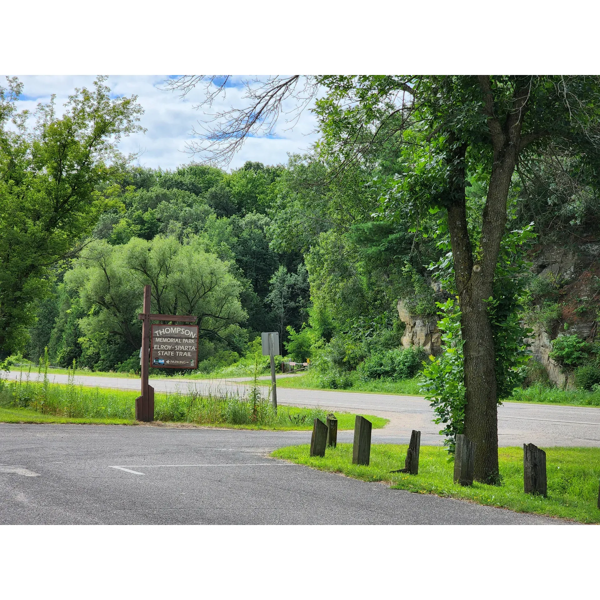 Surrounded by the beauty of nature and the allure of adventure, Elroy Walk-In Campground presents a serene escape along the scenic Elroy-Sparta State Trail. This campground is a haven for outdoor enthusiasts seeking a tranquil retreat with low-frills, yet well-maintained amenities. Embracing simplicity, the campground offers manual pump wells which are an excellent opportunity for team-building as you and a companion work together to draw water—an authentic camping experience.

The campground's grounds are known for their cleanliness, including the well-kept toilet facilities which are a testament to the dedication to providing campers with a comfortable stay. Although traditional firewood sales are not available, resourceful campers can gather wood from the surrounding areas to create a warm and inviting campfire experience, perfect for roasting marshmallows under the starlit sky.

Strategically located, the campground has ample parking space with easy permit acquisition, ensuring a stress-free start to your outdoor getaway. For avid cyclists, the Elroy-Sparta State Trail beckons, with convenient bike rentals and trail passes available a short five-minute journey from the parking lot, opening up miles of scenic trails for exploration.

The natural setting of Elroy Walk-In Campground is embraced with sites that are generously spaced, offering ample room for larger tents and group activities. Selections of sites are available to accommodate bigger gatherings, ensuring that everyone can enjoy the great outdoors together. The lush canopy of trees provides soothing shade and a cool reprieve during the warm summer months.

Campers are encouraged to bring wagons or similar utility carriers to traverse the short uphill journey from the parking area to the campsites, where the true essence of a walk-in campground is experienced. Despite its proximity to the highway, which adds an element of convenience for travelers, the campsite's atmosphere maintains a rustic charm.

Elroy Walk-In Campground invites you to immerse yourself in the outdoors, where the gentle rustle of leaves and the peaceful ambiance offer a unique camping experience—perfect for those looking to disconnect from the bustle of city life and reconnect with nature. Description by ChatGPT.