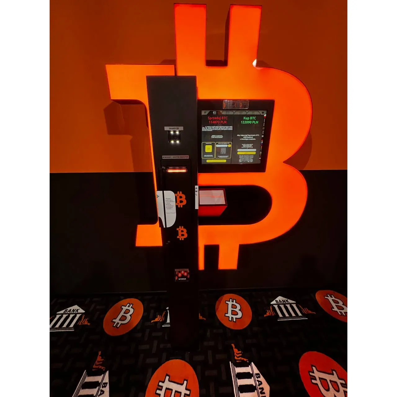 Bitomat - Bitcoin ATM - Shitcoins.club offers a sleek and modern design that stands out to anyone interested in cryptocurrency transactions. This innovative terminal invites users with its user-friendly interface, allowing for seamless operations. While providing a streamlined experience, the machine caters to digital currency enthusiasts who prefer direct, physical interactions for their transactions. The aesthetically pleasing ATM serves as a convenient access point for entering the world of digital finance, creating a bridge between traditional cash handling and the cutting-edge realm of cryptocurrency. The unit's presence in strategic locations offers an essential service for those looking to manage their digital assets in a fast and straightforward manner. Description by ChatGPT.