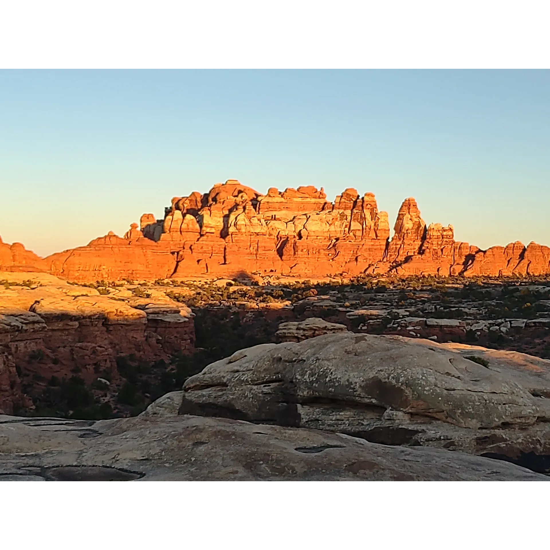 Devils Kitchen Campground offers an exceptional outdoor experience for those looking for solitude and immersion in nature's splendor. Accessible to those willing to venture off the beaten path, the campground is an oasis of peace, promising tranquility and an escape from the hustle of everyday life. With majestic views and pristine natural landscapes, guests are treated to a visual feast that captures the heart of Canyonlands.

The campground boasts a variety of campsites, each with its own unique charm and attributes. Whether you choose site 1, 2, 3, or the spacious and private site 4, you'll be enveloped by the awe-inspiring beauty of The Needles. Though some sites offer more immediate views than others, all guests have access to breathtaking scenery just a short walk from their campsite.

Devils Kitchen Campground is a year-round destination, with October standing out as an excellent month to enjoy perfect camping and hiking weather, complemented by calm and serene conditions. The facility ensures convenience for its visitors with amenities such as well-positioned pit toilets, enhancing the comfort of your stay without detracting from the natural environment.

Site 5 presents a truly unique camping experience, situated beneath an enormous overhanging rock that provides natural shelter from the elements, ensuring that even when the weather turns, your adventure can continue undisturbed.

A stay at Devils Kitchen Campground is not just a night under the stars; it is an unforgettable adventure where the majesty of Canyonlands unfolds before you, offering a cherished respite for outdoor enthusiasts and nature lovers alike. The effort to reach and book a spot at this amazing campground is a worthwhile investment in your quest for pristine wilderness and memorable experiences. Description by ChatGPT.