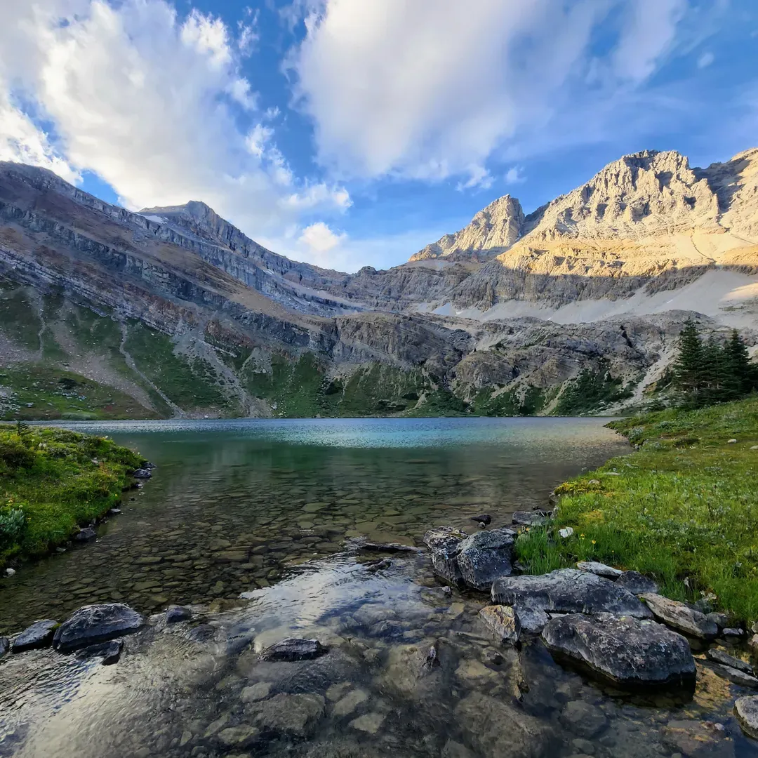 Hidden Lake is a tranquil oasis that promises an unforgettable escape into the great outdoors. A jewel of nature, this pristine destination offers an invigorating adventure for hikers who delight in the fresh mountain spring running down the picturesque terrain, accompanied by the serene presence of local wildlife along the trail. Once you move beyond the ski lifts, the trail transforms into a path of exploration leading to panoramic views and pure, alpine air.

Visitors seeking serenity will find solace in the peaceful ambiance that Hidden Lake provides, where relaxation and the enjoyment of fresh, open air are paramount. The area is known for its superb conditions for outdoor activities, boasting clear waters perfect for reflective moments, as well as a campsite conducive to creating lasting family memories.

Hidden Lake presents an extraordinary setting for camping enthusiasts. After a manageable 1 km hike from camp, the lake area becomes an idyllic spot for cooking and dining, with gentle breezes, warm sunshine, and notably fewer mosquitoes, elevating the outdoor experience. Enthusiasts of the wilderness and pristine environments are unsurprisingly drawn to Hidden Lake, with its crystal-clear waters offering a window to the depths below, ensuring that every visit is truly wonderful and contributes to making this destination a great view to cherish. Description by ChatGPT.