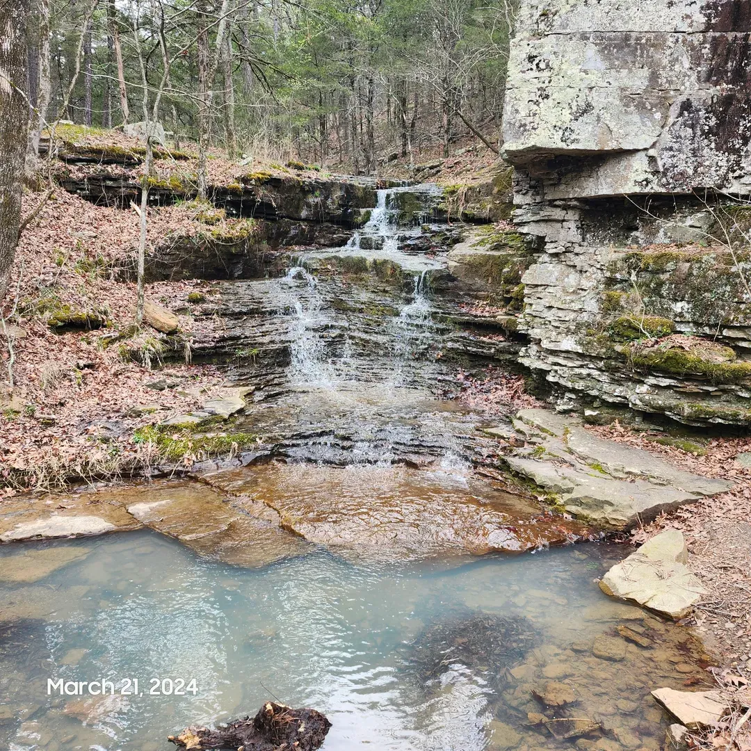 Quail Valley offers a serene escape deep in the lush embrace of the Ozarks, within the storied bounds of Devil's Den State Park. This cherished destination is a paradise for those seeking to disconnect and immerse themselves in the tranquility of nature. Guests revel in the seclusion of the well-appointed campsites, which serve as the perfect launch pads for a day's adventure or an evening under the stars.

Surrounded by the natural splendor of verdant forests and rugged landscapes, visitors find a sanctuary that exists in harmony with the flora and fauna of the region. The iconic Butterfield trail, steeped in history and scenic beauty, edges through Quail Valley, offering hikers and nature enthusiasts an opportunity to traverse one of the region’s most picturesque paths.

Moreover, Quail Valley isn’t just about its stunning vistas and peaceful environment – it's a beacon for outdoor enthusiasts and families alike. With trails that cater to all levels of experience, every visitor can find joy and rejuvenation amidst the towering trees and winding pathways.

Elevating the outdoor experience, the park lovingly preserves the scenic integrity of the Ozarks. Here, visitors are invited to indulge in moments of reflection, engage in heart-pumping exploration, and create memories that will linger long after their departure. Embrace a sojourn in this idyllic setting where natural beauty abounds and life’s simpler pleasures are celebrated. Description by ChatGPT.