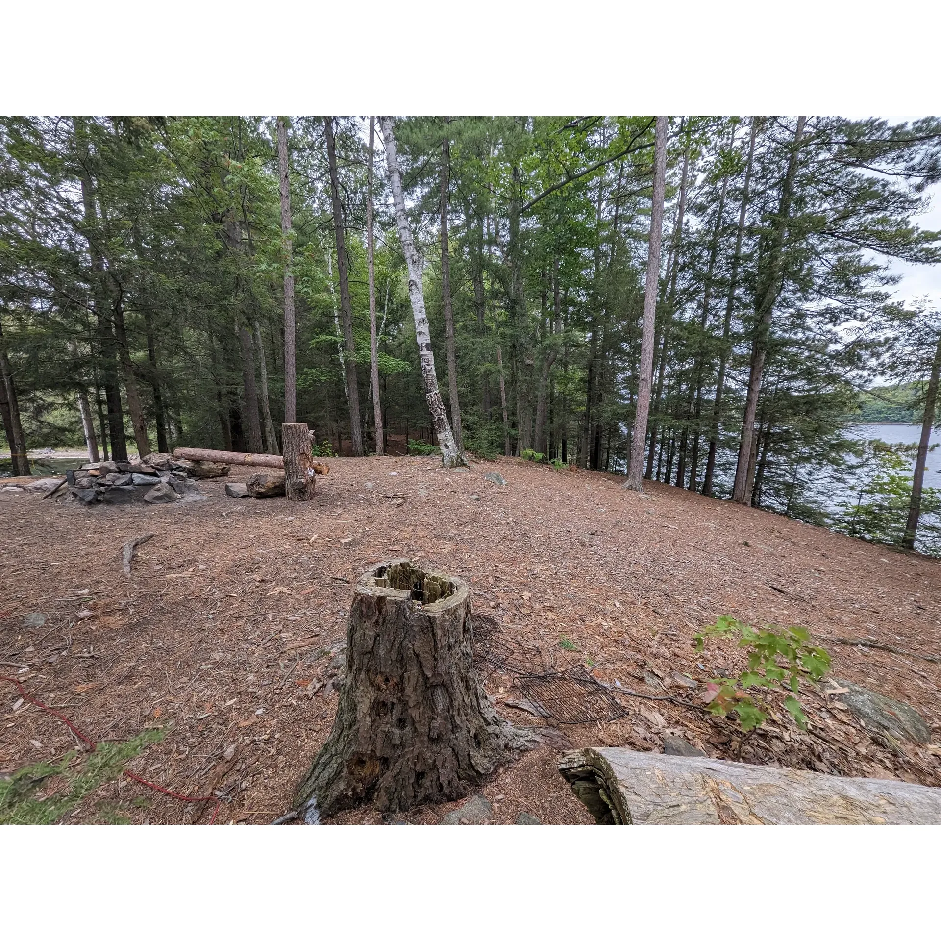 Backcountry Campsite #15 at Killarney Lake offers adventurers an authentic wilderness experience with the comforts of environmental protection. Perched along the scenic shores, this campsite is a haven for those seeking to immerse themselves in natural beauty while maintaining a level of shelter from the diverse weather conditions.

Visitors to this site will delight in discovering various vantage points from which they can soak in panoramic views that capture the essence of Killarney's rugged landscapes. The surrounding area provides an ideal backdrop for outdoor enthusiasts to create unforgettable memories amidst the tranquility of untamed nature.

The campsite is equipped with essential amenities to ensure a comfortable and practical outdoor stay. It's a serviceable choice for travelers intent on exploring the splendor of Killarney Lake and the wildlife that flourishes within this picturesque setting. As you settle in for the night, the symphony of nature will lull you to sleep under a canopy of stars, rounding out a true backcountry experience. Description by ChatGPT.