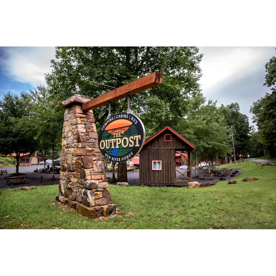 The Outpost - New River Gorge Campground is a premier destination for adventurers and nature lovers alike, offering a picturesque and convenient base for exploring the stunning surrounds of the New River Gorge area. With an array of accommodation options to suit every traveler's need, our well-maintained campground provides the perfect blend of comfort and outdoor living.

Our spacious RV spots are fully equipped with hook-ups, as well as a fire pit and picnic table, creating a homely environment where guests can unwind under the stars. Those seeking a more rustic experience can settle into our cozy cabins or pitch a tent at one of our well-appointed tent sites, complete with solo stoves for that authentic camping vibe.

Cleanliness and convenience are at the heart of The Outpost experience, evidenced by our impeccably maintained restrooms and showers, convenient on-site laundry facilities, and a large green space where children can play freely in the fresh air. Dog owners will be delighted to find our campground welcoming for their canine companions, ensuring that the whole family can enjoy a memorable stay.

When it comes to location, guests will appreciate our proximity to the New River Gorge Visitors Center, just two miles away, allowing for easy access to park activities and attractions. For any necessities or last-minute supplies, large retail stores are conveniently located within a short drive.

The Outpost isn't just about relaxation; it's also a hub of community and entertainment, offering musical performances on weekends and a lodge house brimming with activities such as TV, games, and more. A treasure trode of recommendations awaits at the front desk, including tips for rainy day explorations.

Whether you opt to nestle into one of our cabins - with ample space to stow your gear - or prefer the serenity of a tent camping spot with breath-taking views, The Outplant ensures your stay is exceptional. Enjoy the novelty of an outdoor shower with spa-like hot water or the convenience of full electric hookups at designated sites.

Above all, The Outpost is celebrated for its friendly, attentive staff and the genuine care they extend to every guest, ensuring that each visit is both personal and memorable. Your adventure at The New River Gorge is not just about spectacular surroundings; it's also about the unparalleled hospitality that awaits at The Outpost - New River Gorge Campground. Description by ChatGPT.