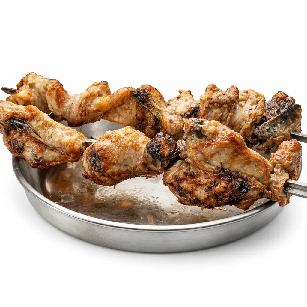 A succulent Mediterranean dish featuring juicy chicken pieces seasoned and grilled on a charcoal BBQ rotisserie, perfect as a main course.