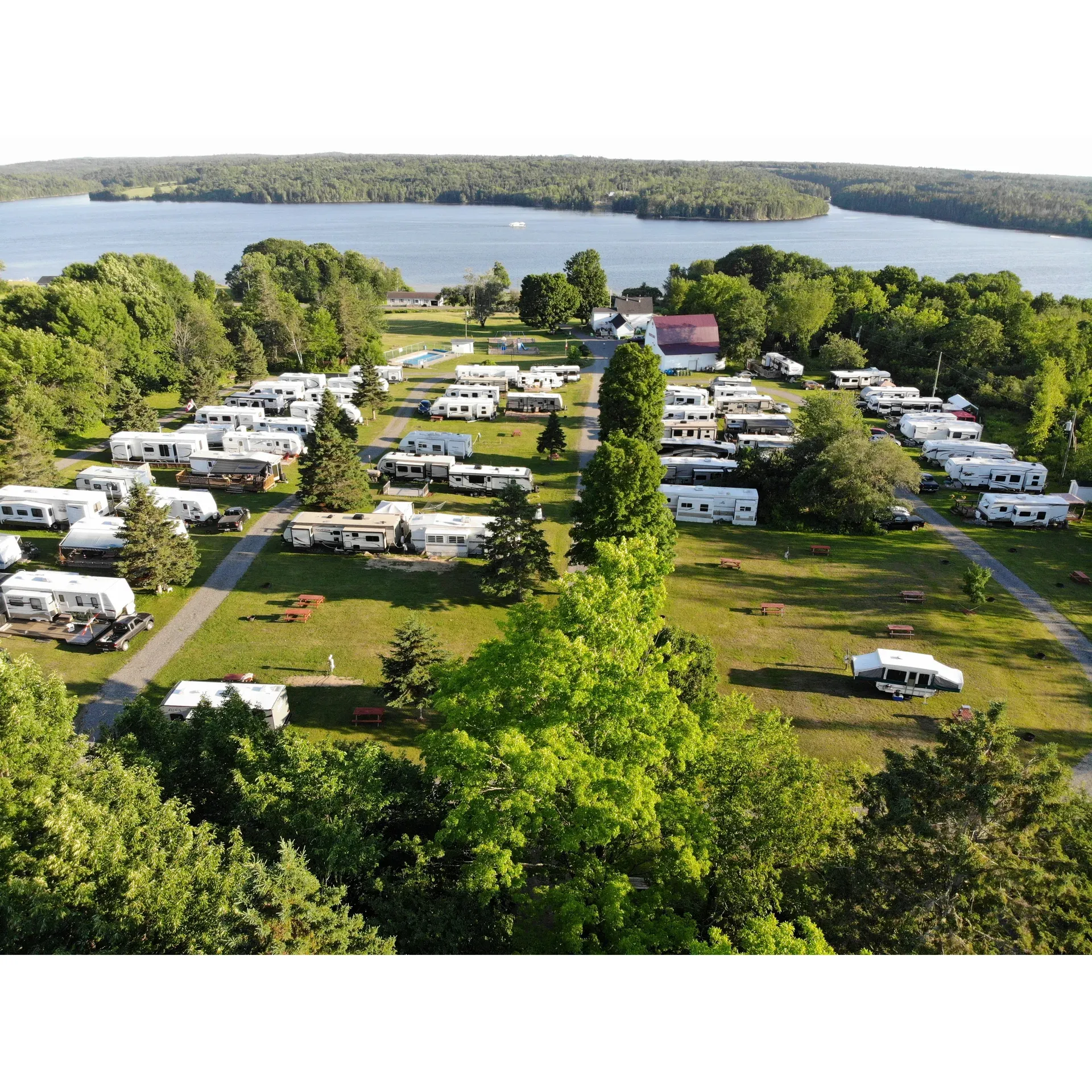 Heritage Country Camping offers a serene and inviting outdoor retreat for campers seeking tranquility paired with thoughtful amenities. The picturesque campsite is acclaimed for its pristine and comfortable sanitary facilities, ensuring guests enjoy a high level of cleanliness and convenience. The dedication to upkeep is evident, with visitors consistently praising the meticulous maintenance and the evident care infused into every corner of the grounds.

Not only is the campground praised for its peaceful atmosphere, but it also boasts top-notch WLAN service, a sought-after luxury in the world of outdoor escapes, which is highly appreciated by tech-savvy campers.

The community spirit at Heritage Country Camping is warm and welcoming, with friendly, neighborly interactions being the norm. It's a place where both the staff and fellow campers contribute to a convivial environment, perfect for families and individuals alike. The site buzzes with the joyful sounds of kids at play, making it an ideal setting for creating cherished memories.

Whether you're looking to bask in the leisurely pace of life or dive into a good book by the pool, you'll find what you need here. The beautifully maintained pool and manicured lawns provide a picturesque backdrop, with stunning views of the St. John River adding to the pastoral charm. Evenings at the campground promise tranquility, with a quiet atmosphere conducive to rest and relaxation.

Venturing slightly off the beaten path to reach Heritage Country Camping is an adventure in itself, with the anticipation building as you traverse the winding approach. And once you arrive, the warm reception by staff and the full range of facilities – including clean restrooms complete with showers, as well as laundry services – ensure all practical needs are met with ease.

Outdoor enthusiasts will also appreciate the natural beauty surrounding the campground, where wildlife sightings, like a graceful deer in the nearby fields, are not uncommon. Whether opting for a cozy tent space or a convenient pull-through site for larger rigs, every guest finds their ideal spot under the sun – or shade, should they choose.

Located a mere 20 minutes from Fredericton, Heritage Country Camping stands out as a gem for visitors seeking both seclusion and proximity to local attractions. With its friendly staff, clean facilities, and the sheer beauty of its setting, this campground is a beloved destination that beckons travelers back time and again. Description by ChatGPT.