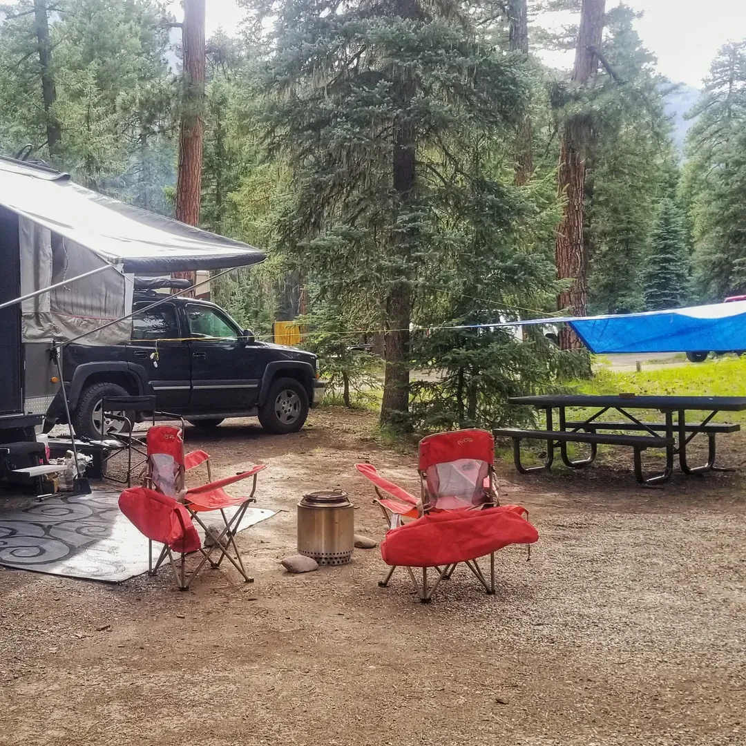 West Fork Campground offers a tranquil and picturesque retreat for outdoor enthusiasts looking to immerse themselves in the beauty of a pristine natural setting. Surrounded by the lush ambiance of a forested landscape, this premier Forest Service campground provides a serene backdrop, perfectly paired with the soothing sounds of the nearby West Fork River.

Campers are greeted by the friendly and helpful host, John, who is known for his cordial nature and valuable local insights, ensuring a welcoming atmosphere from the moment of arrival. The grounds are meticulously maintained with cleanliness being a top priority, and this attention to detail extends to the well-kept pit toilets, which are regularly serviced for the comfort of guests.

Each campsite offers its own slice of privacy and seclusion, with ample space between neighbors fostering a sense of peace and exclusivity. For those seeking an intimate connection with nature, site 16 comes highly recommended, offering not only the auditory delight of the river's flowing waters but also a splendid view to accompany the natural lullaby.

The campground boasts convenient amenities, including accessible potable water spigots and strategically placed trash bins at the entrance. Firewood is readily available for purchase, allowing campers to enjoy the timeless tradition of a crackling campfire under the stars. For added convenience, the sites are situated within close reach of delightful hikes, offering opportunities to explore the great outdoors.

Positioned near a charming meadow and just a stone's throw from the highway, the campground is easily accessible while still providing an escape from the hustle and bustle of daily life. Its proximity to Pagosa Springs ensures that any necessities forgotten at home can be easily procured, adding to the ease of your wilderness getaway.

For those adventurous spirits, the surrounding area presents a gateway to Wolf Creek Pass along with miles of National Forest roads begging to be explored. The campground is not just a base but a starting point for countless adventures that await in the sprawling landscape.

Guests have repeatedly expressed their fondness for the campground's beautiful and awe-inspiring setting, from the majestic river's edge to the towering cliffs that frame the area. The commitment to safety and environmental stewardship is apparent, with the campground host thoughtfully guiding visitors in responsible fire practices to preserve the area's natural splendor.

Ultimately, West Fork Campground embodies the essence of outdoor tranquility and charm, delivering an exceptionally clean, safe, and friendly environment that beckons nature lovers to retreat, relax, and rejuvenate amidst the forest's serene embrace. Description by ChatGPT.