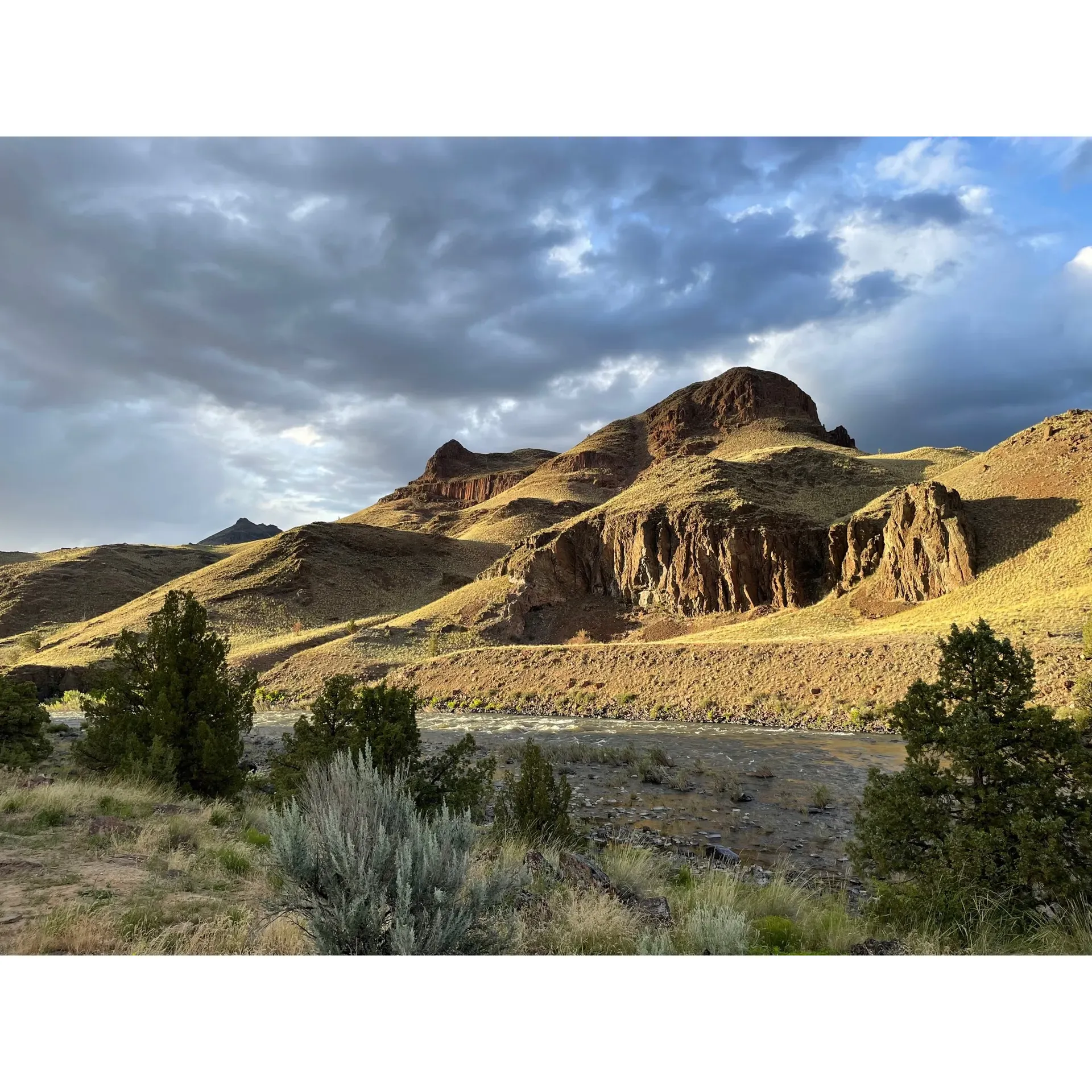 Discover the enchanting Burnt Ranch Campground, an idyllic retreat for both adventure seekers and those looking to unwind in the great outdoors. Set amongst breathtaking landscapes alongside the tranquil John Day River, the campground offers a plethora of scenic spots perfect for setting up your tent. With easy river access, campers can look forward to fishing, swimming in the shallows, or simply basking in the summer warmth of the gently flowing waters.

For those who revel in exploration, Burnt Ranch Campground provides ample space to venture around and discover the hidden trails leading directly to the water's edge. Adventure extend beyond the campgrounds, as it is conveniently located about 20 minutes from the mesmerizing Painted Hills, inviting you to delve into the splendid hues of this natural wonder.

Despite its remote charm, the campground offers the convenience of a public covered bathroom, allowing for a comfortable stay amidst the wilderness. Visitors often praise the ample camping spots available, offering enough seclusion for an intimate experience with nature. With the promise of clear night skies, it's also a prime spot for stargazers to marvel at the celestial wonders above.

While the journey to Burnt Ranch Campground is part of the adventure itself, traversing the gravel roads that carve through the terrain, a 4WD vehicle is recommended to navigate certain stretches with ease. This only adds to the sense of escapade as you make your way to this secluded paradise.

For those needing supplies or fuel, the nearby town of Mitchell is just a short drive away, ensuring you can easily replenish essentials before returning to your tranquil riverside sanctuary. Whether you're looking to escape the hustle and bustle of daily life or craving a rustic, outdoor experience, Burnt Ranch Campground is the quintessential setting for creating lasting memories amidst the splendor of Oregon's natural beauty. Description by ChatGPT.