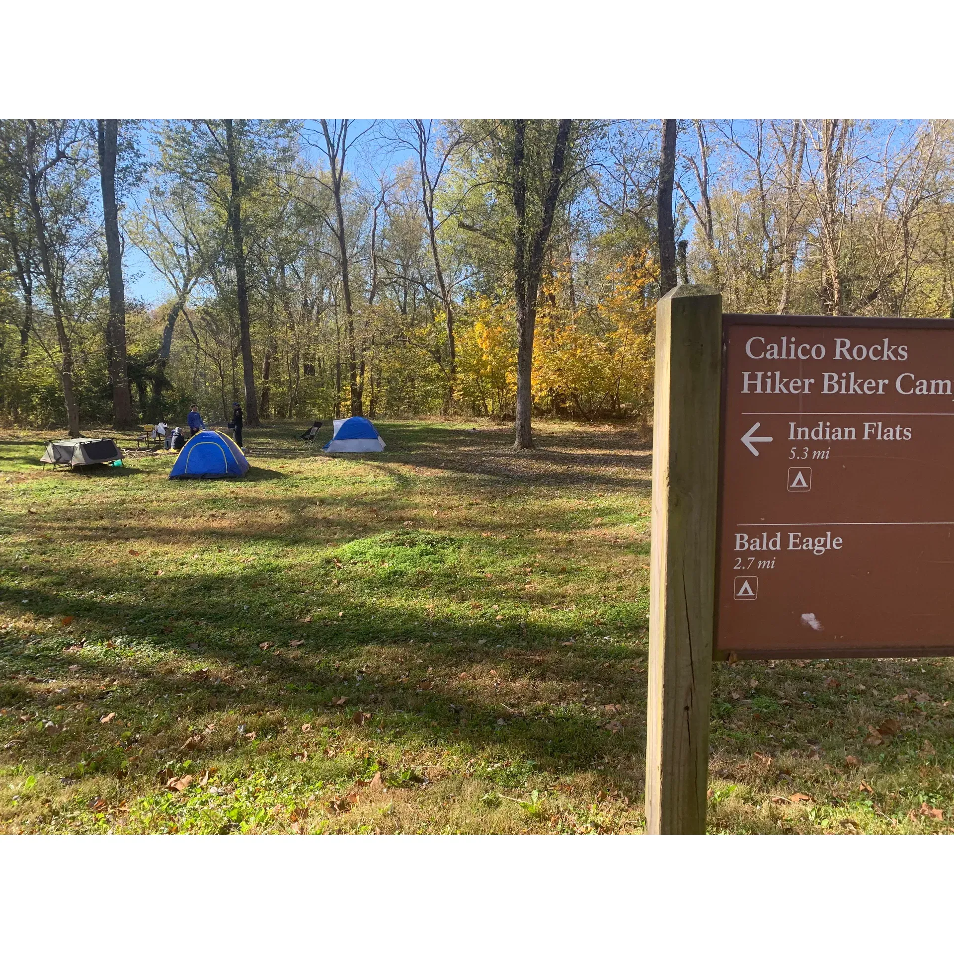 Calico Rocks Campsite offers visitors an authentic outdoor experience with its expansive grounds designed for adventure and relaxation. Conveniently located close to the scenic Point of Rocks, the campground presents an opportunity for guests to immerse themselves in nature's beauty.

Campers at Calico Rocks can delight in direct river access that provides not only a stunning backdrop but also the chance for various riverside activities, including cooling off in the refreshing waters during warmer months. The site's excellent and somewhat quaint beach area further enhances the allure of waterside recreation, perfect for leisurely days spent soaking up the sun.

For those who love open spaces, Calico Rocks Campsite boasts a vast area that invites families to spread out and find their perfect spot for setting up camp. Kids will find tons of fun exploring the surroundings, where the views include the mesmerizing flow of the river and the intriguing sights of railroad tracks that add a nostalgic touch to the panorama.

Practical amenities are taken into consideration at the campsite, ensuring that the essentials for a comfortable stay are in place. A functional water pump provides a traditional means to fetch water, adding to the rustic camping experience. Additionally, cleanliness is a priority, with well-maintained porta toilets for visitors.

The spirit of camping is kept alive with a designated fire area, ideal for gathering around as the day turns into night, sharing stories, or ro soasting marshmallows under the stars. While guests may need to bring their own firewood or collect some from the surrounding areas, the charm of a crackling campfire remains a cornerstone of the Calico Rocks camping experience.

Despite its simplicity, Calico Rocks Campsite captivates with its blend of natural beauty, basic amenities, and the magnetic charm of the outdoors. It's a superb choice for campers seeking an uncomplicated, yet thoroughly enjoyable, return to nature. Description by ChatGPT.