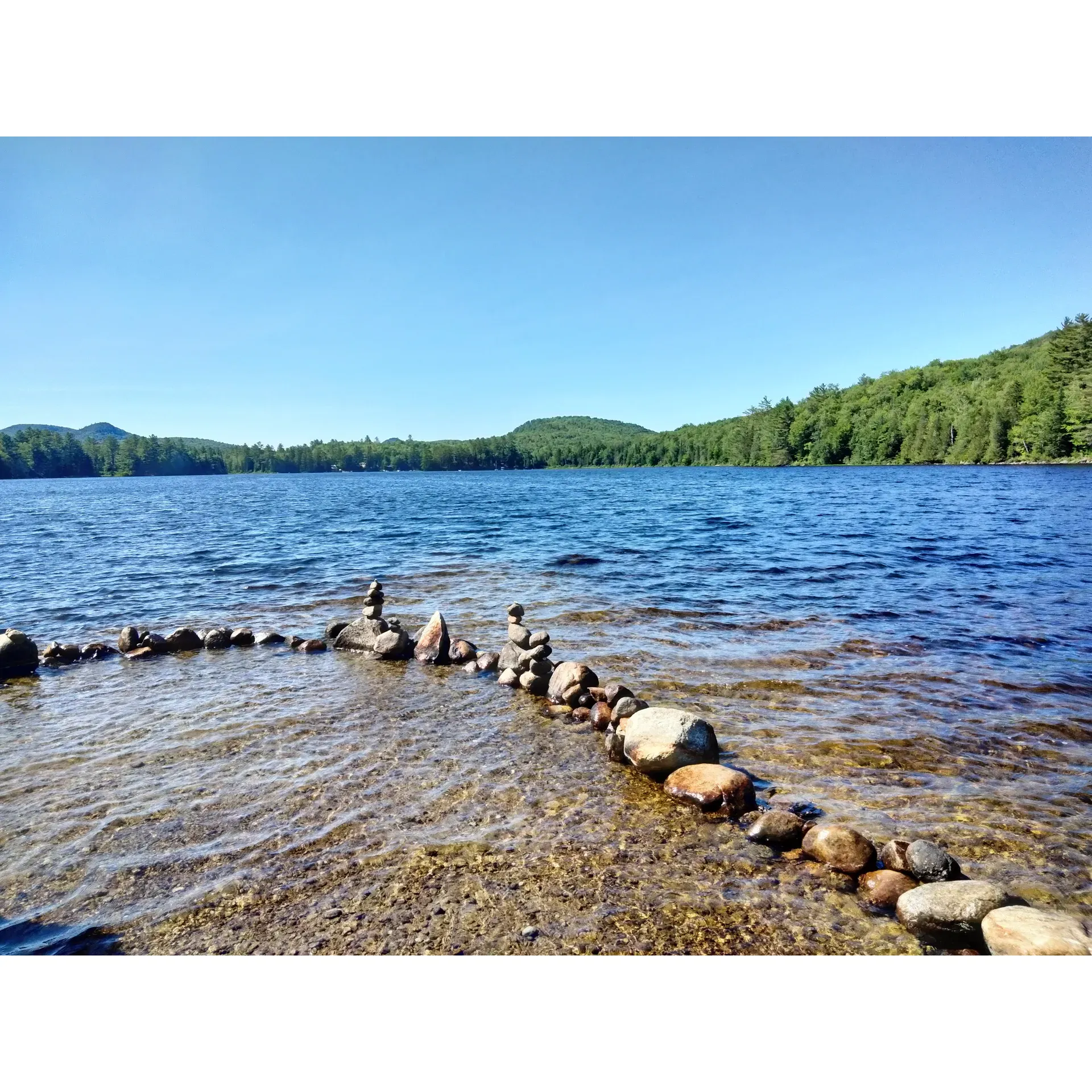 Ricker Pond State Park offers an idyllic retreat for outdoor enthusiasts looking to reconnect with nature. The park boasts serene and spacious tent campsites that provide visitors with a sense of privacy and tranquility, making it a perfect getaway for those looking to escape the hustle and bustle of daily life. Kayakers will revel in the calm waters of the park's namesake pond, while the small beach area offers a sandy haven for relaxation and sunbathing.

The surrounding area is a haven for hikers and cyclists, with abundant rail trails providing ample opportunities to explore the picturesque landscapes. Attention to detail is evident throughout the park, as evidenced by the pristine condition of the campsites. Upon arrival, guests will find well-maintained spaces with clean fire pits and neatly-raked grounds, ensuring a comfortable and inviting environment.

International visitors, including those from as far as Ontario, Canada, make repeat visits, signifying the park's universal appeal. The lean-to accommodations are a popular choice, providing a unique and memorable lodging experience. Nearby, a refreshing waterfall serves as an enchanting swimming spot, complemented by the easy-to-access beach that boasts stunning views.

RV enthusiasts will find a selection of prime locations tailored to their needs, while those preferring a bit more shelter can opt for one of the cozy cabins set amidst the park's stunning rock formations. The park's management is dedicated to ensuring a top-quality experience for all visitors, contributing to the park's reputation for excellence.

Described as breathtakingly gorgeous, Ricker Pond State Park is a tucked-away treasure that promises a peaceful visit, often without the crowds found at more popular destinations. Visitors seeking natural beauty and an off-the-beaten-path adventure will find themselves immersed in a landscape that outshines even the most well-known attractions.

In addition to its many amenities, the park features a delightful campground that complements the overall outdoor experience. The pond itself is a delightful spot for swimming, offering comfortable water temperatures that have been noted as particularly enjoyable on warm summer days. With its harmonious blend of scenic beauty, recreational offerings, and commendable upkeep, Ricker Pond State Park stands out as a must-visit destination for those who cherish the outdoors. Description by ChatGPT.