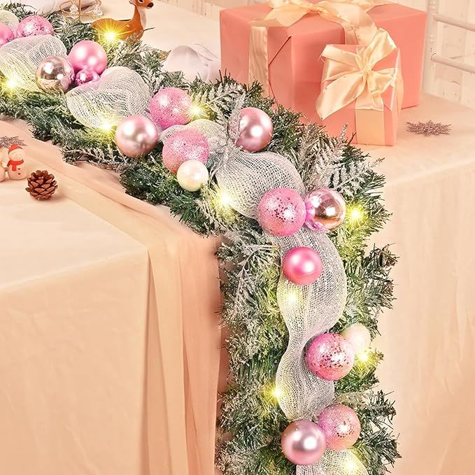 Christmas garland decorations are a popular way to add holiday cheer to your home during the festive season. This 5.9 ft Christmas garland for mantle features a snow flocked design with ribbons, white and pink Christmas balls, and frosted pine branches, creating a whimsical and winter-themed look.