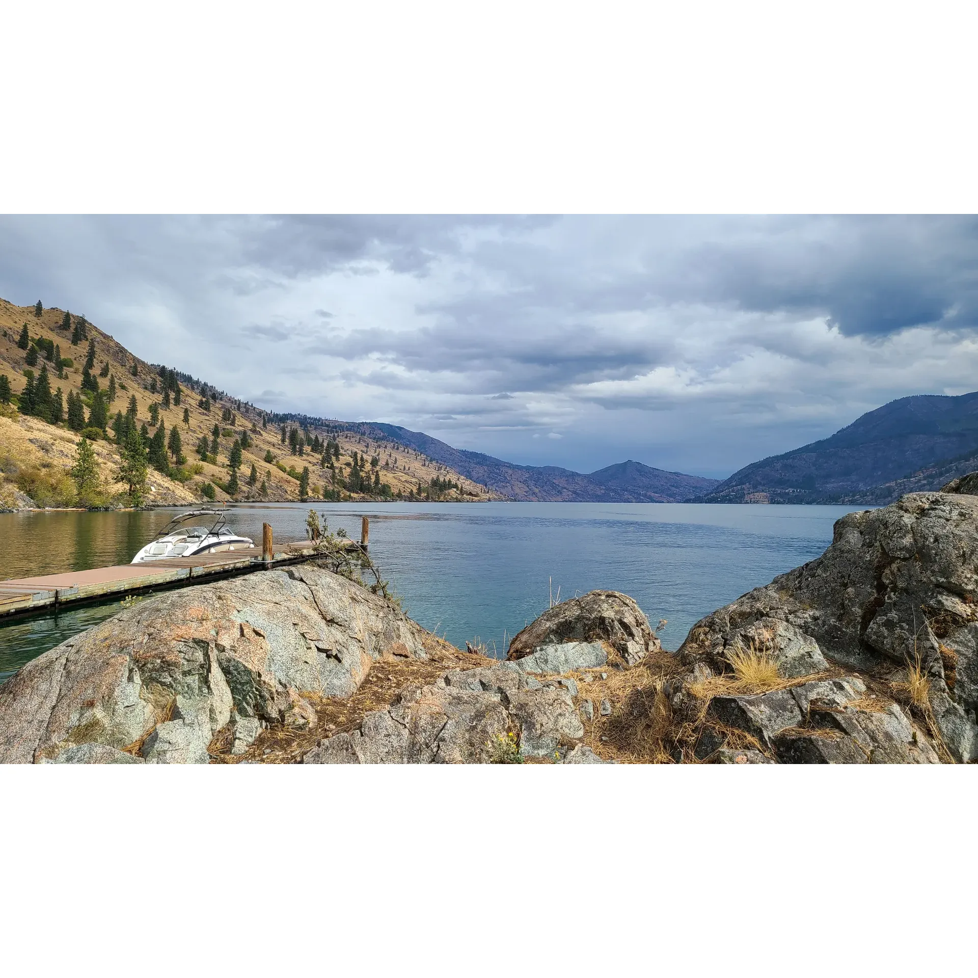 Deer Point Boat-In Campground offers an idyllic outdoor retreat for those seeking tranquility and natural beauty within the stunning setting of Lake Chelan. A favorite among boaters, this serene sanctuary provides ample space for up to four boats to moor comfortably, making it a convenient mid-way stopover on the journey between Chelan and Stehekin.

Adventure-seekers and nature lovers can indulge in refreshing swimming and rewarding fishing experiences amidst panoramic views. The campground boasts four to five well-appointed tent sites, each accompanied by tent pads, providing a spacious and comfortable setting for campers to connect with the great outdoors.

Well-equipped for a rustic yet cozy camping experience, the site features a pit toilet maintaining environmental integrity without sacrificing the conveniences of home. Each site also offers fire rings with grills for cooking up a delightful outdoor meal while soaking in the surroundings. For those who enjoy a leisurely nap in nature, several stately trees are perfectly positioned to support hammocks for a soothing rest under the canopy.

Exemplary down-lake wind protection is a unique feature of Deer Point Boat-In Campground, with strategically placed campsites on both the up and down sides of the lake to ensure visitors can find a calm spot, regardless of the day's conditions. Meanwhile, full-day sun exposure guarantees that sunseekers can bask in the warm glow throughout their stay, complemented by breath-taking up-lake views that are sure to enchant.

For those wishing to explore further, the campground's proximity to 25 Mile Park via a brief 5-10 minute boat ride adds a touch of convenience to the adventure. Multiple spacious areas provide an abundance of room for tents, offering majestic vistas to the north and south, inviting guests to immerse themselves in the picturesque beauty of what many consider being the most beautiful place in Washington.

Visitors to Deer Point Boat-In Campground will find themselves enveloped in a picturesque setting that caters to a relaxing and unforgettable camping experience, where the splendor of nature and thoughtful amenities combine to create a perfect lakeside getaway. Description by ChatGPT.