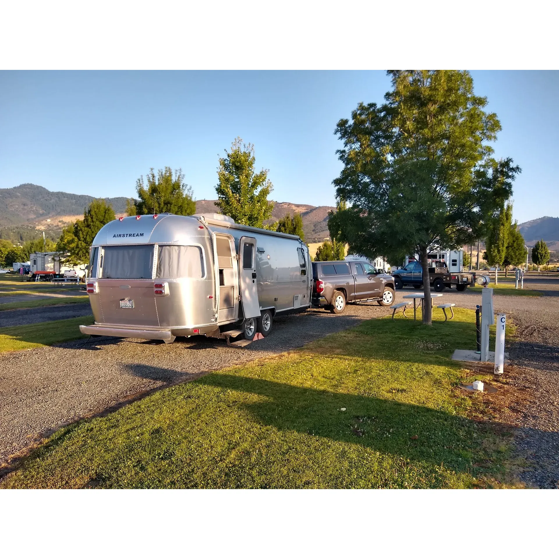 Yreka RV Park offers a peaceful and accommodating stop suitable for both short-term guests and those looking to enjoy a longer stay. Conveniently located with easy access from I-5, this serene destination provides well-maintained pull-through spots that cater seamlessly to larger RVs, like a 37ft 5th wheel, offering an uncomplicated parking experience.

The park prides itself on its exceptional customer service, with a polite and helpful team that is committed to ensuring a smooth and comfortable experience for every guest. The facilities, encompassing bathrooms and a laundry room, are consistently lauded for their cleanliness and sanitary condition, providing a home-like environment for all visitors.

Among the many amenities, guests appreciate the expansive open areas that offer a delightful space for pets to freely roam, albeit with the absence of a designated dog park. Furthermore, the park shows a dedicated concern for pet safety with a great dog park that avoids escape hazards, despite some playful obstacles being laid out flat.

Families with children will find delight in the on-site play gym, offering a safe and enjoyable space for kids to engage in. Additionally, the proximate truckstop enhances the convenience factor, providing a full-service center, fuel options as well one could ask for.

For those concerned about connectivity, Yreka RV Park does not disappoint, offering WiFi services alongside a decent laundry facility. The well-appointed green strips add a touch of nature and relaxation to each RV spot—perfect for pets and children. Regularly serviced garbage facilities and dependable daily mail and package delivery add to the comfort and convenience of stay.

Rates at the park are competitive, and the overall maintenance, including the well-kept grass at each site, garners positive mentions, reflecting a commitment to a neat and orderly environment. The office staff, especially the manager Crystal, is renowned for their friendliness and diligence, ensuring the park's aesthetic is always up to standard.

Whether it's a quick overnight refuge or a longer respite from the road, Yreka RV Park offers an inviting and restful stay, with the tranquility to refresh weary travelers and create an overall enjoyable RV park experience. Description by ChatGPT.