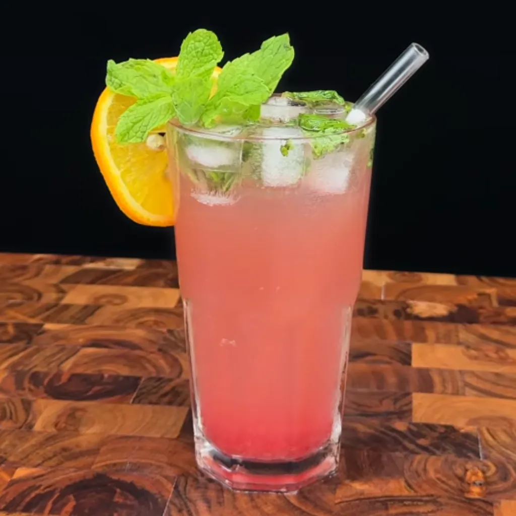 Capture the essence of a sunset with this vibrant and refreshing mocktail, the Sunset Serenade. With its fruity base and invigorating mint aroma, this non-alcoholic beverage is perfect for unwinding or as a delightful accompaniment to warm weather moments. Easy to make and visually striking, it's sure to impress.