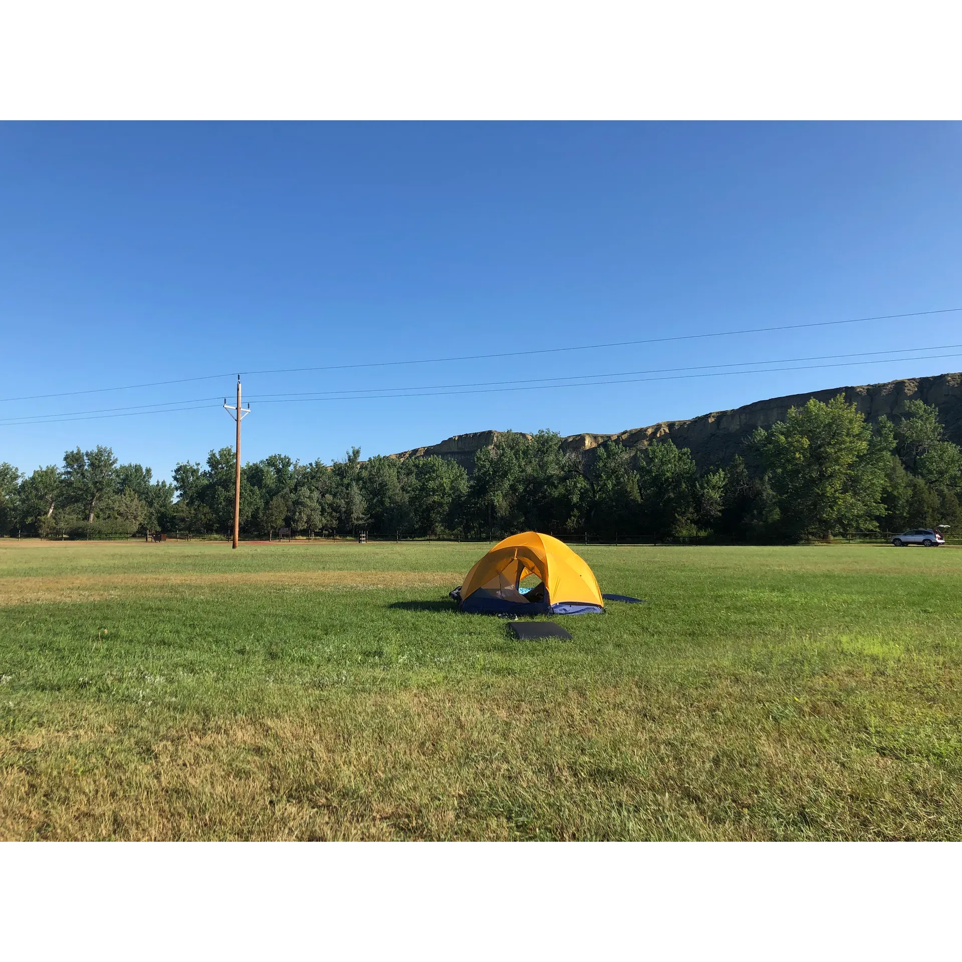 Whitetail Flats Campground emerges as an exemplary outdoor retreat, offering guests a blend of modern amenities and natural beauty. Renowned for its expansive green landscapes and an open central space that rivals a football field, this campground provides a sanctuary for campers seeking serenity beneath a canopy of stars. The grounds are meticulously maintained to ensure a verdant setting that enhances the camping experience.

Visitors appreciate the hospitality showcased by the friendly and accommodating host, who goes the extra mile to cater to guests’ needs, including providing pet lovers with a spacious area where their furry companions can joyously run and play. The commitment to guest satisfaction is further highlighted by the cleanliness and accessibility of the shower facilities, which are praised for being exceptionally well-kept and available around the clock.

Birdwatchers and nature enthusiasts will find themselves in a haven for avian observation, surrounded by wide open spaces that beckon explorers. Whitetail Flats positions itself as a premium choice for those embarking on a journey to Theodore Roosevelt National Park, with its close proximity offering ease of access while still retaining the charm of seclusion. 

The campground provides ample amenities such as electrical hookups, accessible water, and a convenient dump site, greatly appreciated by those traversing the terrain in RVs or staying in the horse camping area. The spacious, well-spaced campsite arrangements echo the campground's commitment to privacy and comfort, allowing guests ample room to enjoy their outdoor abode.

Offering excellent value within a picturesque setting, Whitetail Flats Campground stands out as a cherished destination for travelers seeking an affordable, yet rich and fulfilling outdoor lodging experience. Whether you're looking to immerse yourself in tranquil nature or desiring a reliable and comfortable basecamp for equestrian adventures, this campground is poised to make your trip memorable. Description by ChatGPT.