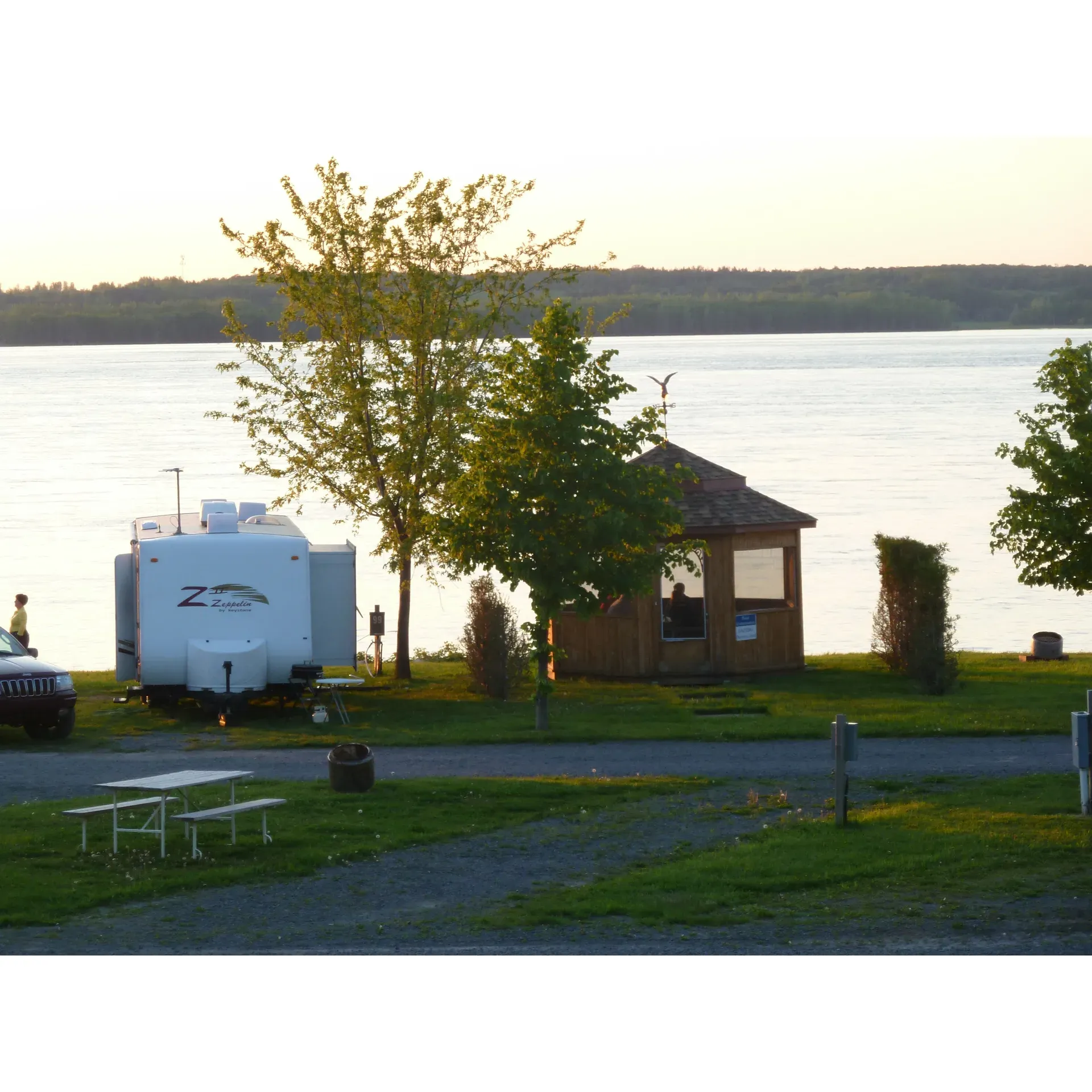 Discover the tranquility and beauty of the great outdoors at Camping Cap a la Roche, a splendid getaway located on the shores of the majestic St. Lawrence River. Here, guests experience exceptional hospitality from a team of friendly staff dedicated to making every stay memorable. The campsite's prime location offers breathtaking riverside views, with premium waterfront sites available that provide an incomparable connection to nature.

At Camping Cap a la Roche, each site is meticulously maintained, offering campers spaciousness and cleanliness that contributes to a feeling of privacy and comfort. Whether you're in a travel trailer or pitching a tent, every spot feels like a personal retreat. Facilities are equipped with amenities designed for convenience and comfort, including free WiFi and reasonably priced firewood, ensuring that all needs are met with ease.

Visitors can indulge in moments of relaxation while watching the grand ships sail by or take pleasure in leisurely strolls along the river's edge, enveloping themselves in peace and the picturesque environment. The park becomes even more alive with the laughter of children enjoying the playful water games—the perfect balance to a soothing day spent by the river.

Throughout your stay, you're supported by a community-oriented team, renowned for their willingness to go above and beyond in service. Feel secure knowing that the dedicated staff is ready to assist in unexpected situations, often leaving guests with heartwarming stories and a strong sense of gratitude.

Camping Cap a la Roche stands as a beloved destination for seasonal adventurers and first-time visitors alike, many of whom eagerly anticipate their next visit. Whether seeking serene solitude by the river or engaging in quality time with loved ones, this park provides an idyllic setting for creating lasting memories amid the natural splendor of the St. Lawrence River. Description by ChatGPT.