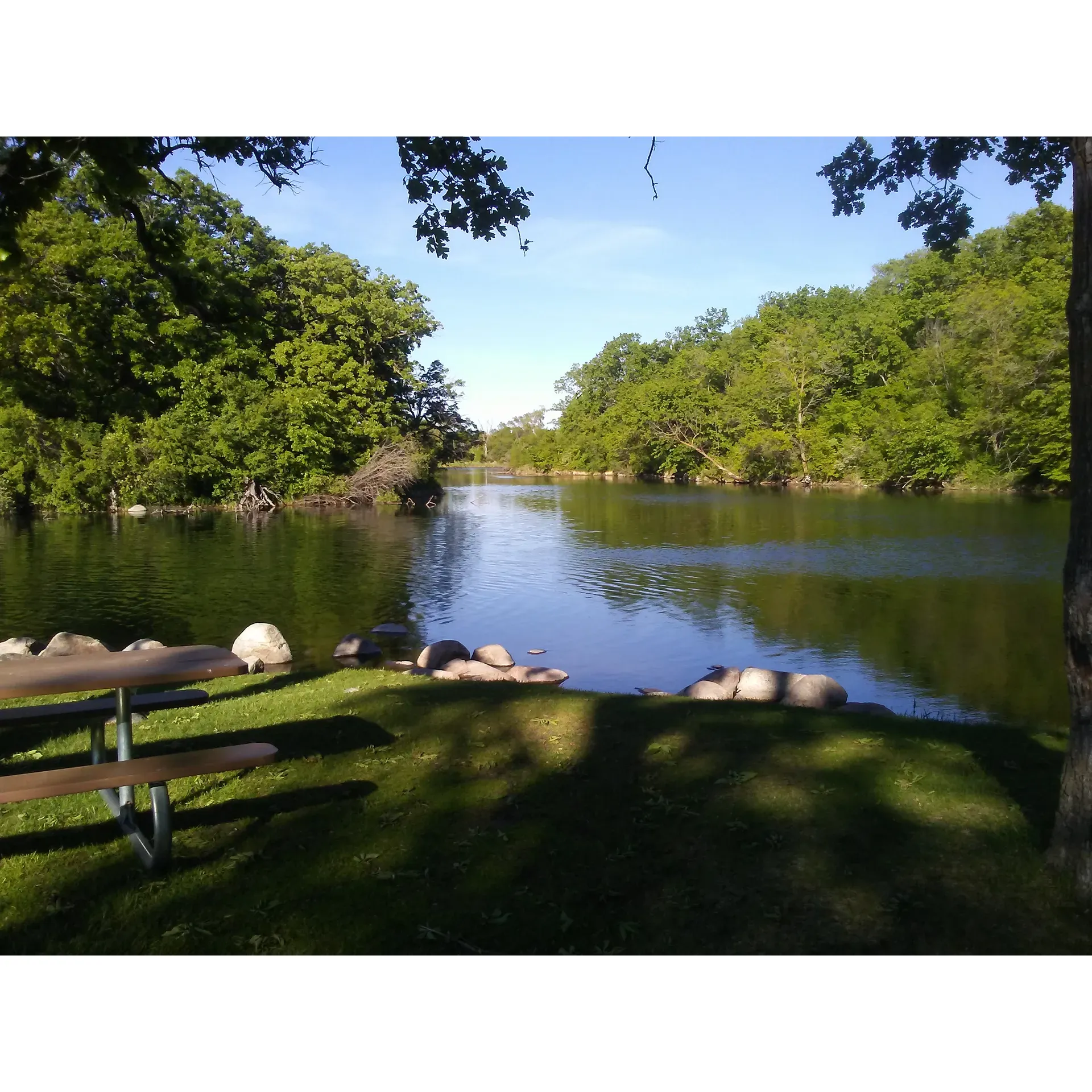 Sherin Park and Campground emerges as an idyllic retreat for travelers looking to immerse themselves in the tranquility of a riverside setting. Bountiful with shade from mature trees and boasting a picturesque view of the adjoining river, this park provides an intimate connection with nature. Ideal for both brief stopovers and longer-term stays, the campground offers affordable rates coupled with vital amenities such as electric hook-ups that add to the convenience of guests. 

Throw in the charm of the local town, easily accessible via a charming suspension bridge, and visitors have the perfect backdrop for creating lasting memories. The presence of wildlife, such as a community of geese, enhances the natural experience without proving to be a nuisance.

Site 10 is highly recommended by seasoned travelers and is lauded as one of the best in the area. The strategic placement of each camping spot, whether back-in or pull-up, complements the diverse needs of campers. While the lack of water or sewer hook-ups might seem like a drawback, the surrounding beauty and the sheer serenity of Sherin Park more than make up for it. Plus, the provision of a shower house ensures that essential hygiene needs are catered for.

Staying connected isn't a problem either, as guests can easily use their own mobile hotspots to access the internet. Moreover, the campground’s proximity to the lake guarantees cooler temperatures for a refreshing reprieve from the heat.

Daytime or night, the park maintains a peaceful atmosphere, inviting guests to enjoy the splendid calm, whether they're inside their RVs or under the stars. Sherin Park and Campground evidently holds a special place in the hearts of those who visit, with many vowing to return whenever they're in the area, proving that this gem of a campground is the perfect venue for both ardent campers and casual travelers alike. Description by ChatGPT.