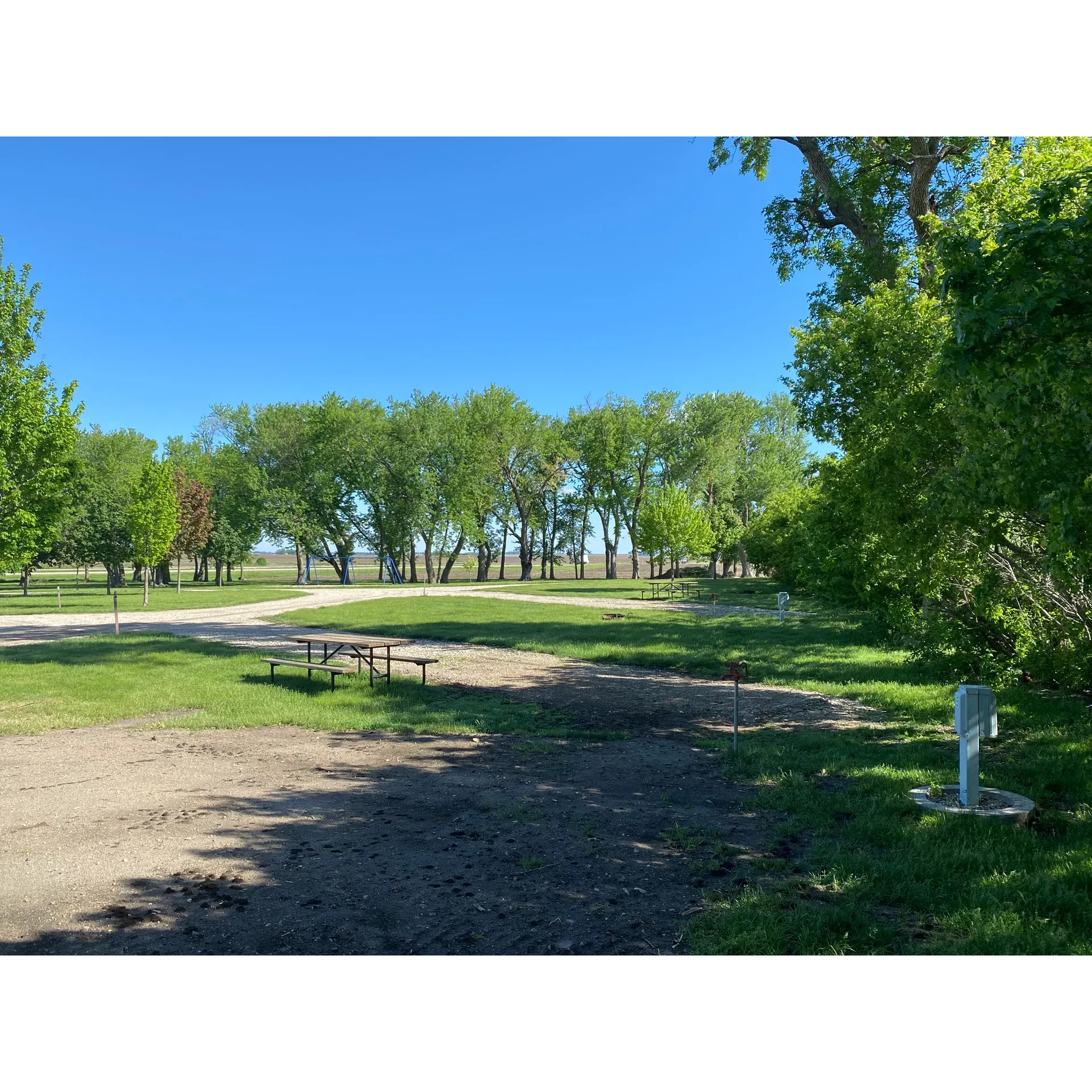 Hawkeye Point Campground offers an inviting retreat for outdoor enthusiasts and travelers alike, boasting a wealth of conveniences that ensure a comfortable stay. The campground presents a selection of well-maintained cement pads, complementing the pristine condition of the surrounding green spaces. This attractive destination reflects the thoughtful care given to its facilities, which include a reliable central dump station that contributes to the overall cleanliness and functionality.

Affordability is a hallmark of the Hawkeye Point Campground experience, with attractive rates that make both short stays and extended visits accessible. The site is equipped to accommodate a variety of camping styles, featuring pads that cater comfortably to both tents and RVs. This inclusivity extends to the provision of various amenities such as 20, 30, and 50 amp electrical hookups, water connections, fire rings, and picnic tables - all conveniently situated at each camping spot.

Comfort and hygiene are given top priority, with well-maintained bathroom and shower facilities that impress with their cleanliness and ease of use. Showers operate without the need for quarters and offer the luxury of quickly accessible warm water, elevating the camping experience to one of simple, unadulterated pleasure.

Social and recreational needs are not overlooked, as visitors will find a friendly community and ample opportunities for relaxation and leisure within the campground’s leafy confines. Numerous shade trees provide a soothing canopy, making for a tranquil escape where one can truly unwind. Moreover, the site is perfect for those interested in local attractions, with 'Iowa’s Highest Point' located conveniently across the road, inviting exploration and adventure.

Hawkeye Point Campground represents a delightful combination of tranquility, cleanliness, and convenience, delivering an enjoyable and memorable outdoor lodging experience. Description by ChatGPT.