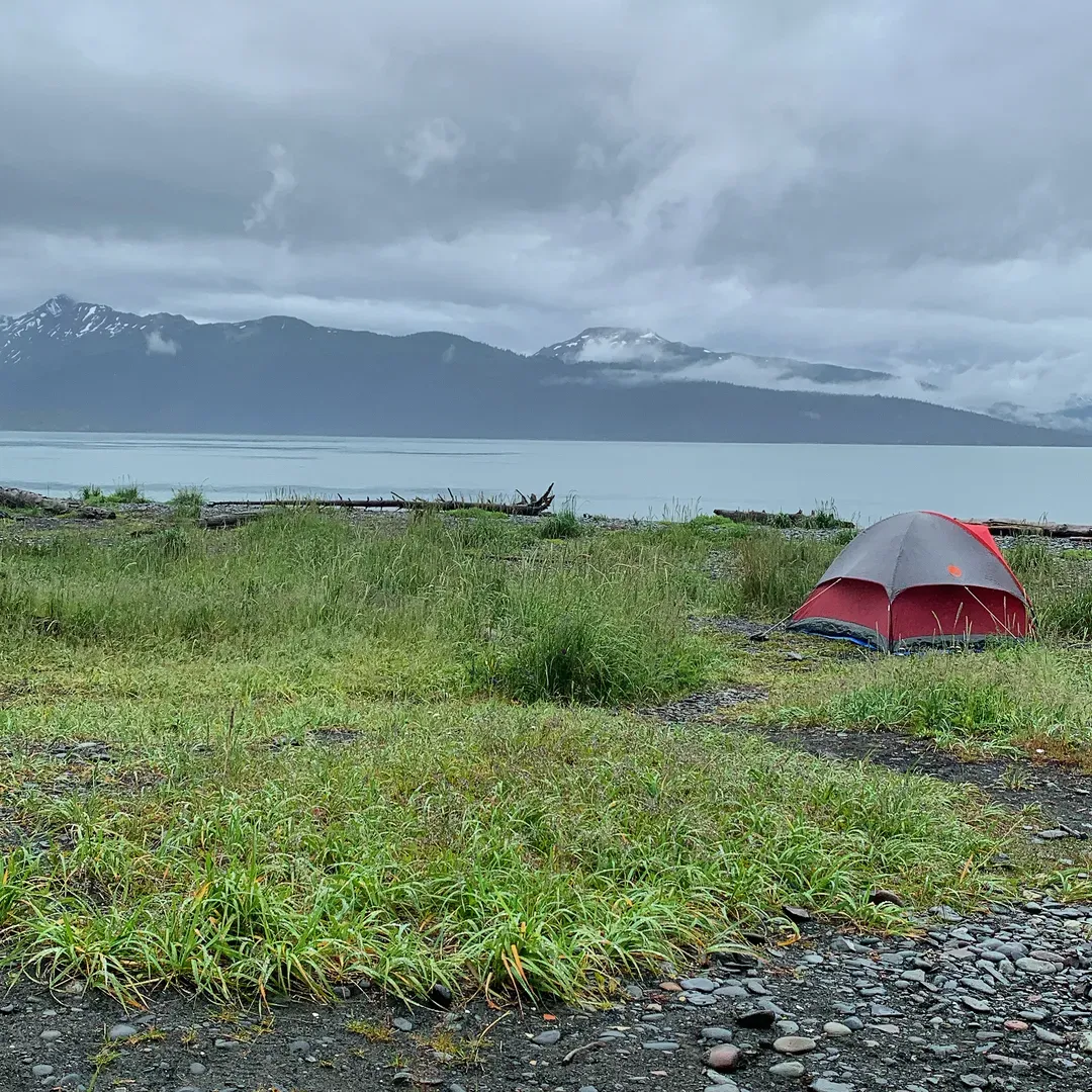 Experience the ultimate Alaskan charm at Homer Spit Campground, an exquisite destination located at the very end of Homer's iconic spit, opening up to the stunning views of Kachemak Bay. Set perfectly for convenience, this campground is merely a short walk from local shops, enchanting eateries, and the bustling harbor where you can watch an array of boats sail by in a serene dance.

With the convenience of both electricity-equipped and dry camping options, visitors can find the perfect spot to suit their style. Each spacious site is thoughtfully equipped with amenities like picnic tables and fire pits, providing a comfortable and communal atmosphere. Electricity access at some sites offers a welcome respite from the traditional camping experience, allowing you to enjoy modern comforts amidst the wild beauty of Alaska.

The campground thrives with life as fellow campers engage in the excitement of fishing, sharing stories, and making memories. The gentle hum of generators may accompany your night, adding to the authentic ambiance of outdoor adventure. Immaculately maintained, the restrooms are consistently stocked and clean, reflecting the staff's commitment to quality.

Remarkable for its location on the beach, Homer Spit Campground promises an unparalleled vista of the surrounding mountains. Beachfront spots serve not just as a place to stay but a panorama to be savored, day or night. For those looking for a touch of luxury in the wilderness, the campground's shower facilities are noted for their hotel-worthy standard, ensuring that you feel refreshed and ready for the day's discoveries.

Embark on a journey with your family or travel solo to find solace or adventure. Homer Spit Campground welcomes every kind of traveler with a team of friendly and helpful staff, always ready to enhance your stay with their expertise and wit. Embrace the vibrant Alaskan spirit, welcome fellow campers like old friends, and indulge in the scenic grandeur offered by this exceptional retreat on Homer's captivating spit. Description by ChatGPT.