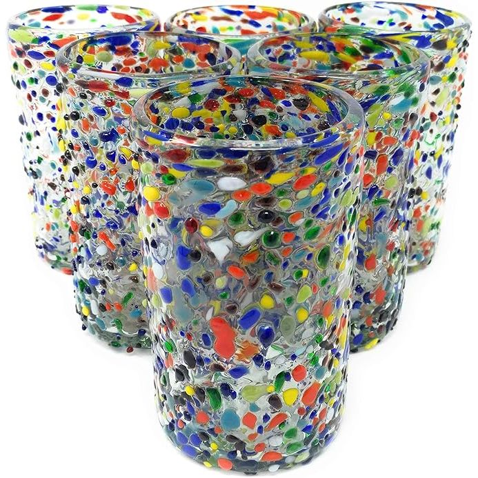 Hand-blown Mexican drinking glasses are traditional artisanal items made by skilled craftsmen in Mexico. This particular set includes six glasses with a fun and colorful confetti rock design, adding a festive touch to your tableware collection.