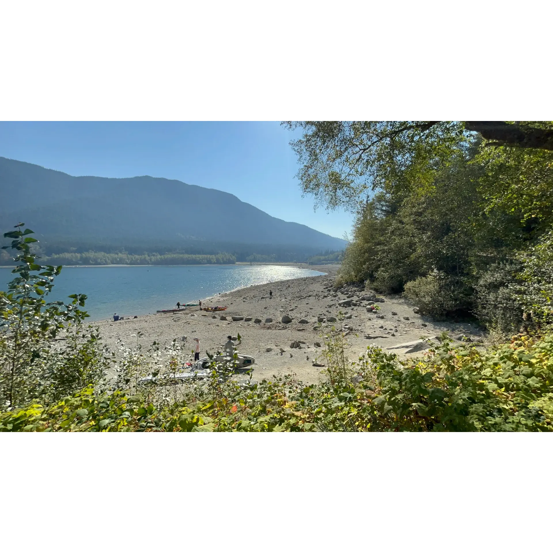 Alouette Lake Southeast Beach, set within the beauty of Golden Ear Provincial Park, is an ideal destination for those seeking a blend of tranquility and adventure. Revel in the splendor of the crystal-clear waters, which shimmer like a vast, green gemstone under the sun. This family-friendly locale offers a wonderful array of outdoor activities to make your summertime visits memorable and thrilling.

Imagine spending your days paddanning or fishing in the serene lake, with majestic views unfolding before you, whatever the weather. With the ability to rent equipment nearby, it's a breeze to take to the water for an unforgettable experience. On terra firma, you can bask in the charm of the expansive beachfront and its well-maintained picnic areas. Thanks to the spaciousness of the site, each visitor is afforded their own slice of paradise, even on busier weekends.

As the day unwinds, you and your loved ones can gather to play games, share stories, and indulge in a savory BBQ as the soundtrack of various local birds enhances your peaceful retreat. The inviting benches dotted along the shore make it easy to sit back and immernehmen yourself in the majestic vistas that spread across the lake. Indeed, Alouette Lake’s Southeast Beach promises an idyllic setting for family gatherings, where laughter and the gentle lapping of lake waves are the backdrop to lasting memories.

Accessibility to the park is seamlessly managed through an online Day-Use reservation system, ensuring that despite its popularity, your visit remains relaxed and enjoyable. If you're planning on a trip during the lively summer weekends, a tip from seasoned visitors: arriving early maximizes your chance to secure the perfect spot for your day out in nature’s bounty.

Alouette Lake Southeast Beach awaits you with its glistening waters, sandy shores, and the promise of pure joy and relaxation for the entire family. Come and discover why it’s hailed as a crown jewel for locals and travelers alike. Description by ChatGPT.