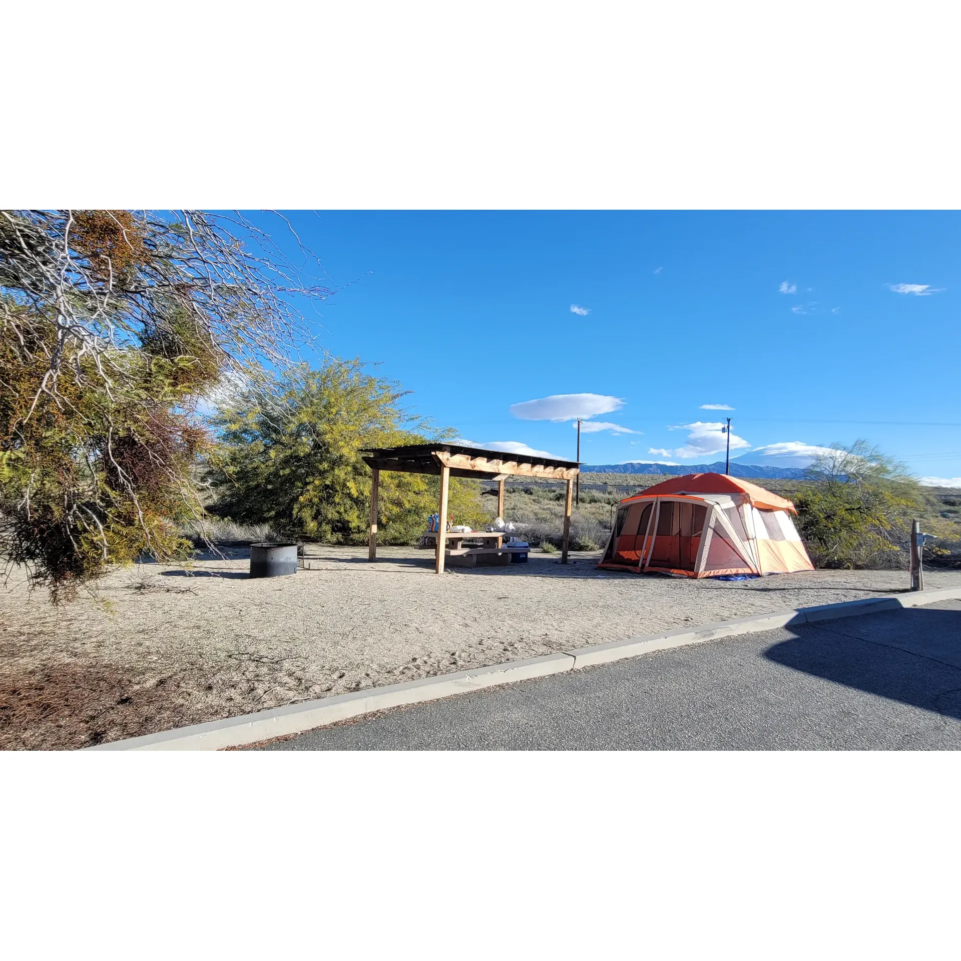 Experience the charm of outdoor living at New Camp Campground, a beautiful retreat by the Salton Sea, offering campers spacious sites equipped with full hookups for the ultimate convenience. Adventure-seekers and nature lovers alike will find a serene escape with each site boasting ample room for large RVs, complete with essentials such as concrete picnic tables, railed shelters for shade and relaxation, and fire pits for cozy evening gatherings under the starlit sky.

Maintained with the highest standards of cleanliness, New Camp Campground ensures a comfortable stay with spotless restrooms and convenient showers. Daily trash pickup services contribute to the pristine environment that guests have come to love.

Those who appreciate attentive service will be pleased to find a friendly and helpful ranger on-site, ready to assist with any needs, enhancing the camping experience. Visitors can enjoy nearby access to potable water facilities, an RV dump station, and hot showers, all included in the affordable nightly fee.

During the week, tranquility prevails, allowing campers to reconnect with nature and unwind in peace. The gorgeous surroundings provide an idyllic setting for beachside picnics and leisurely days spent soaking in the stunning landscape. Although the Salton Sea's waters are not suitable for swimming, the locale serves as an excellent base for exploring nearby attractions like Bombay Beach, just a brief drive away.

For those who prioritize a roomy and pristine camping environment, New Camp Campground stands out as an exceptional choice. The campground's prime spots, such as sites 48, 49, and 50, offer awe-inspiring views of the Salton Sea, ensuring an unforgettable visit for all who choose to stay.

As a celebrated outdoor destination, New Camp Campground invites you to create lasting memories amidst its well-appointed facilities and spectacular natural beauty. Description by ChatGPT.