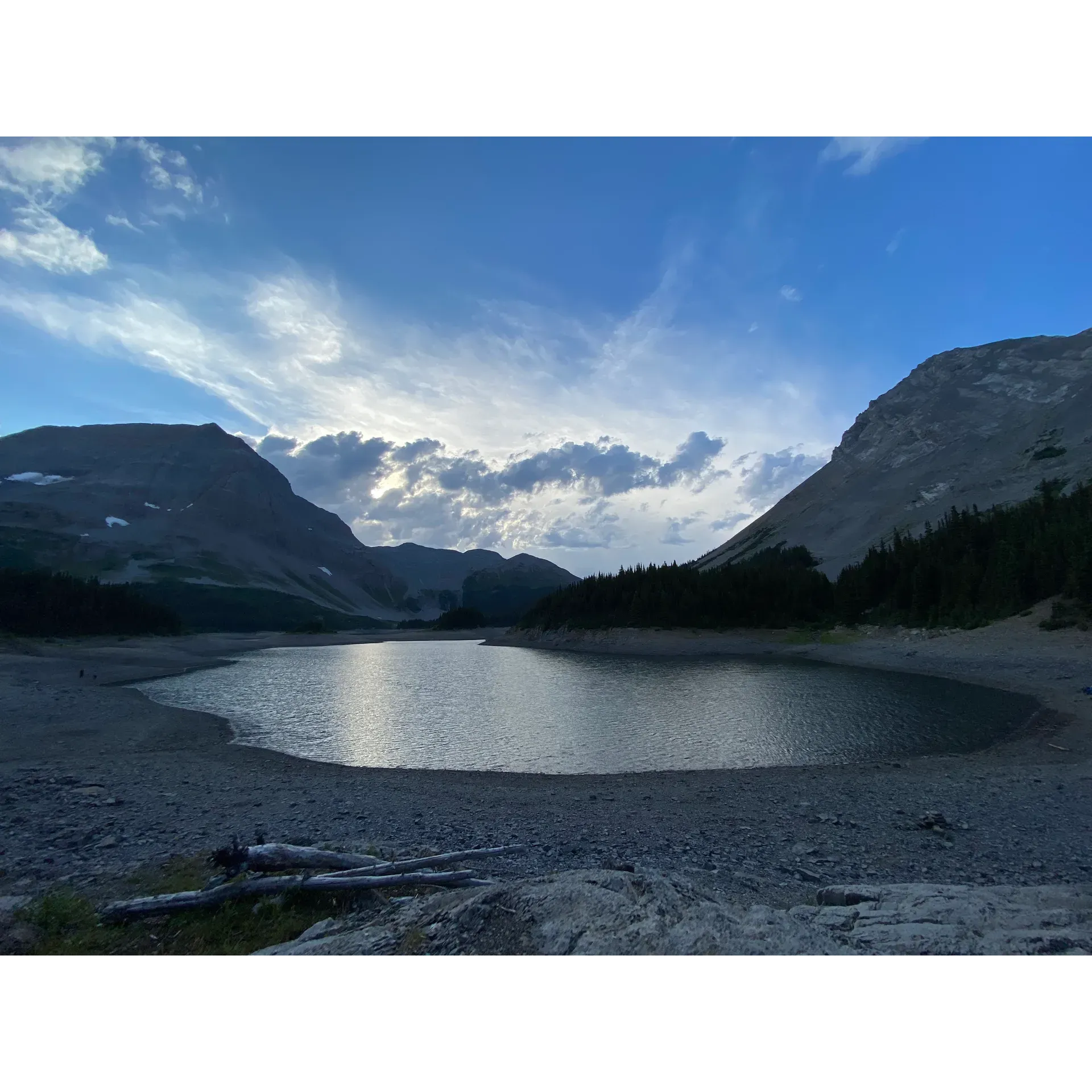 Immerse yourself in the timeless beauty of the great outdoors at Three Isle Lake Backcountry Campground. This haven offers outdoor enthusiasts an unparalleled opportunity to connect with nature and fellow campers in a serene and picturesque setting. Wake up to the enchanting sounds of nature and witness the unrivaled splendor of sunrise reflections on the lake, a truly captivating spectacle for early risers. 

Three Isle Lake Backcountry Campensorableism provides ample amenities to ensure a comfortable wilderness experience. Savor the convenience of bear lockers, ensuring your provisions are secure, and communal tables, perfect for sharing meals and stories with new friends. The campground boasts well-maintained facilities, including a reliably clean outhouse, adding an element of comfort to your stay.

Explore the beautiful surroundings with ease, knowing your basecamp offers 15 large tent pads, each spacious enough to accommodate a 4-person tent. While fire pits are not a feature of this campground, the ready availability of bear lockers provides ample storage for your camp stove and supplies, ensuring you can still enjoy cooking in the wild.

Outdoor enthusiasts are encouraged to plan ahead, as this sought-after destination is a favorite among hikers and adventure-seekers alike. Booking your spot online is simple and can be done up to three months in advance through the AlbertaParks website, allowing for a stress-free start to your adventure.

Whether you're plunging into the invigorating waters of the lake for a swim, embarking on one of the many surrounding hikes, or simply enjoying the camaraderie at the campground, Three Isle Lake Backcountry Campground offers an exquisite retreat for those in search of tranquility, natural beauty, and a touch of adventure. Description by ChatGPT.