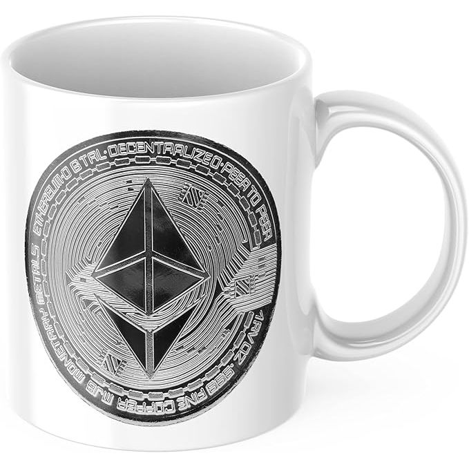 The Ethereum Coin Mug is a coffee mug made of white ceramic with a capacity of 11 ounces. It features a crypto blockchain design with an image of an Ethereum coin and the word "Eth" printed on the front.