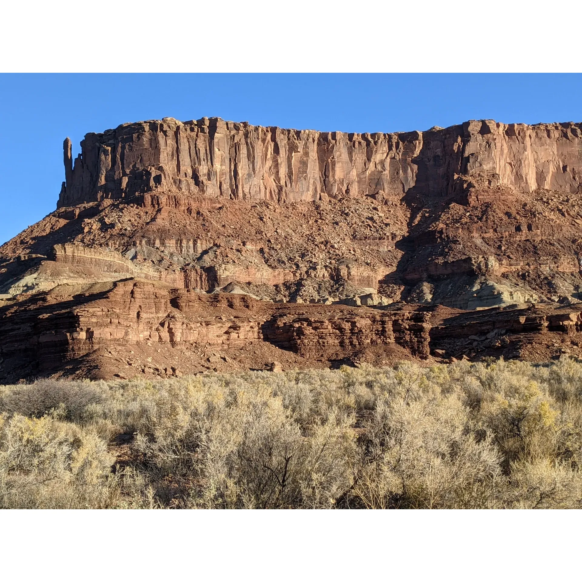 Potato Bottom Campground B offers a truly remarkable outdoor experience for the adventurous camper. The fine sandy terrain provides a unique, soft landscape that adds an element of wilderness luxury to your tent setup, making for a comfy, albeit pervasive, natural carpet. Those with a sense of adventure and a capable 4x4 vehicle will find the journey down the breathtaking White Rim Trail to be an exhilarating part of the camping experience, with stunning vistas and thrilling driving. 

Once at the campground, visitors are treated to the serene beauty of the surrounding scenery, with access to the Green River complementing the remote, untouched environment. Here, campers seeking solitude and a break from the hustle of modern life will find peace. Potato Bottom Camp Has a basic infrastructure, including a vault toilet, ensuring that the area remains as undisturbed as possible, offering a true 'off the grid' experience while still providing essential facilities. 

Campers here can enjoy the rare blend of isolation, natural beauty, and challenging access that makes for an unforgettable trip. With the added luxury of natural shade, visitors can escape the heat and settle into a comfortable, tranquil retreat in the heart of nature. It's an optimal choice for those looking to immerse themselves in the great outdoors and enjoy a rustic camping experience in a truly extraordinary setting. Description by ChatGPT.