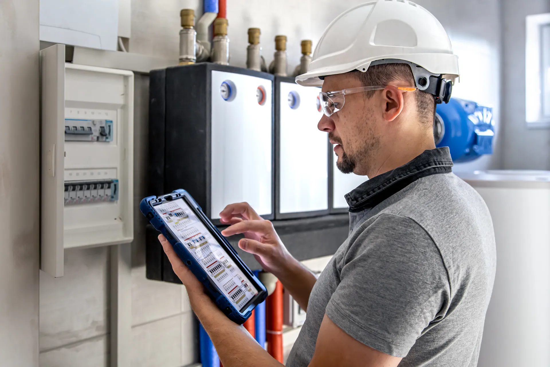 electrical-technician-looking-focused-while-working-switchboard-with-fuses (1).jpg
