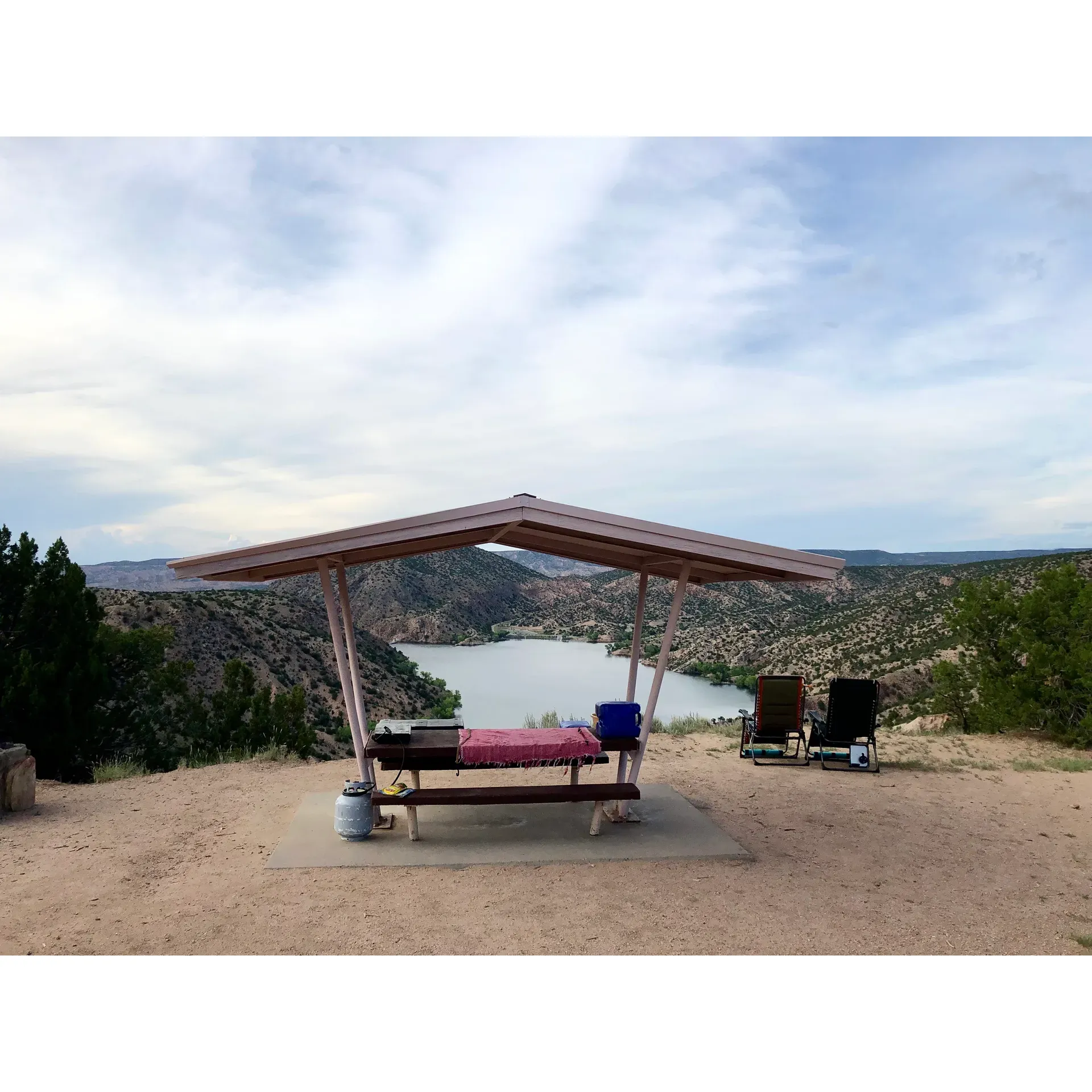 Overlook Campground offers an enchanting escape into the great outdoors approximately 40 minutes from the bustling arts scene of Santa Fe. Visitors are often delighted to find themselves surrounded by breathtaking landscapes, with the exquisite Overlook Lake providing a serene backdrop for each day's activities. This tranquil haven boasts a limited number of campgrounds, ensuring an intimate connection with nature and often a peaceful solitude, with twelve well-maintained sites that cater to various setups, from back-in sites for cars, campers, and vans to drive-thru spots suitable for larger rigs.

The campground's prime location offers stunning panoramic vistas of snow-capped mountains and allows for captivating hikes down to the lake, inviting campers to immerse themselves in the natural beauty. Outdoors enthusiasts and amateur astronomers alike revel in the excellent stargazing prospects, with only mild light interference from nearby Santa Fe illuminating the nighttime sky. 

For those who treasure cleanliness and convenience, the site affords well-kept restroom facilities (outhouse type), although there is no water supply, campers are encouraged to bring in what they need. With fantastic cellular reception, staying connected, even amidst the wilderness, is surprisingly easy for those who desire it.

Noteworthily priced at $9 per night, Overlook Campground is a true gem for those seeking a delightful, budget-friendly outdoor retreat. Nature's splendor, combined with the serene atmosphere and necessary amenities, make for an experience that many find well worth the venture—a delight for the soul and a respite for the adventurous heart. Remember to honor the campground's pristine conditions by following the Leave No Trace principles, ensuring that this magical place remains undisturbed for fellow nature lovers to enjoy. Description by ChatGPT.