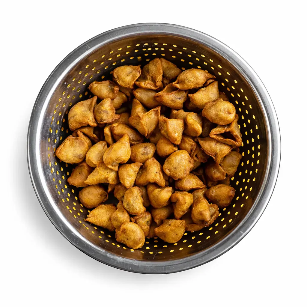 Nellaidhoo Kudhi Bajiya is a traditional Maldivian fish samosa filled with a savory blend of fish and coconut, deep-fried to a crispy perfection, perfect for snacks or appetizers.