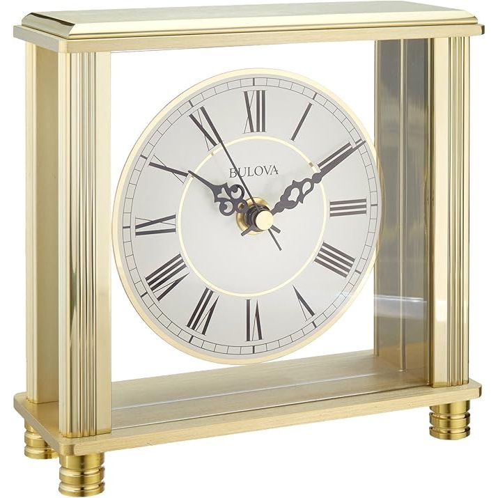 The Bulova B1703 Cheryl Table Clock is a beautifully designed brass clock that adds a touch of elegance to any room. The clock features a classic and sophisticated design with a traditional brass finish, making it a timeless piece that will never go out of style.