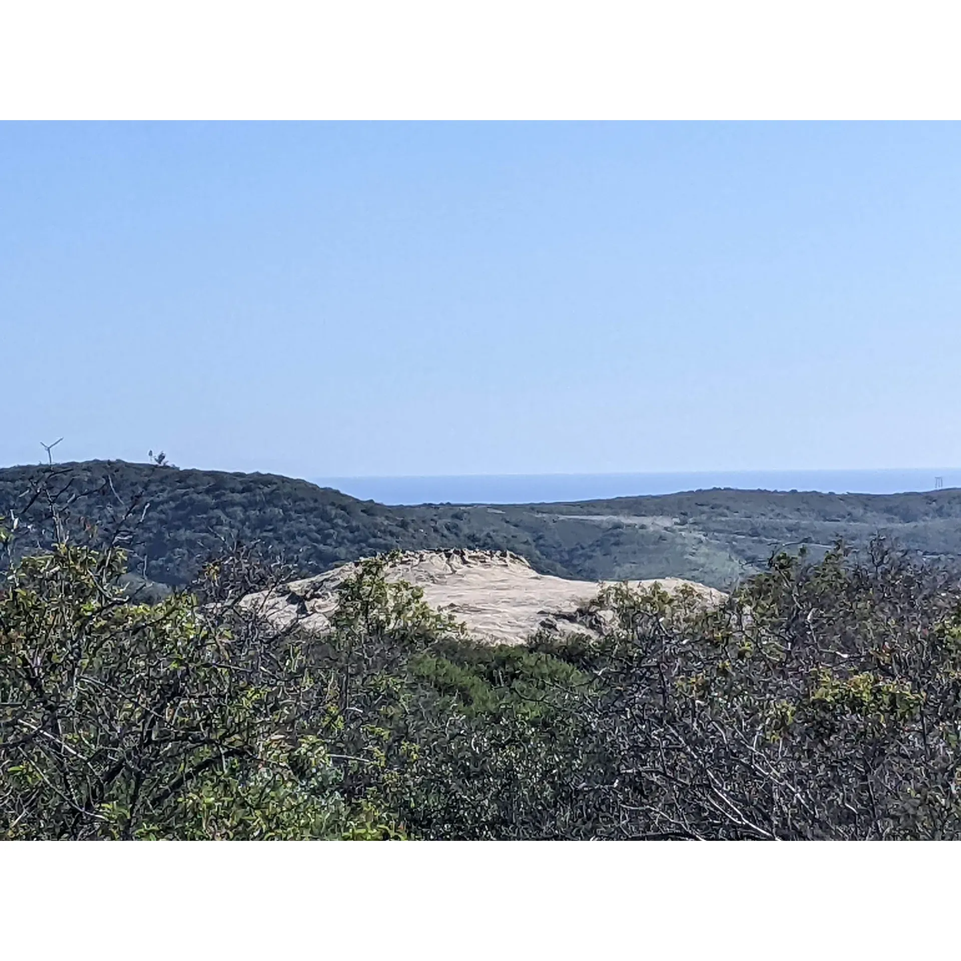 Deer Canyon Campground offers a unique outdoor experience for adventure enthusiasts looking for a challenge and a scenic retreat. Embark on a 2.5-mile trek, which may test your endurance, as you make your way to this well-maintained wilderness haven. The trail, kicking off from the Visitor Center parking lot, takes you through the beautiful chaparral, alive with native fauna and flora, creating a stunning backdrop for your journey.

Upon arrival, visitors are greeted by a clean campground equipped with two trash receptacles to ensure the preservation of the natural setting. Facilities include a well-stocked clean vault toilet offering a comfortable camping amenity. While the campground does not feature water sources, it compensates with its serene environment and the convenience of picnic tables at most sites, perfect for a leisurely meal surrounded by nature.

Deer Canyon Campground, while easily accessible from the road, encourages a sense of proximity to the wilderness, promoting a brief yet authentic outdoor experience. The campground's location makes it an ideal destination for a quick overnight adventure or a test run for your backpacking gear. This undisturbed natural landscape serves as a serene getaway by day and a peaceful respite by night.

As the day dawns, the surrounding trails come to life with hikers and bikers, adding a liveliness to the early morning hours and ensuring you start your day with the energy of nature's enthusiasts around you. Deer Canyon Campground exemplifies the natural beauty Orange County has to offer, providing a picturesque setting for short camping trips and nature encounters designed to disconnect from the daily grind and reconnect with the simple pleasures of the great outdoors. Description by ChatGPT.