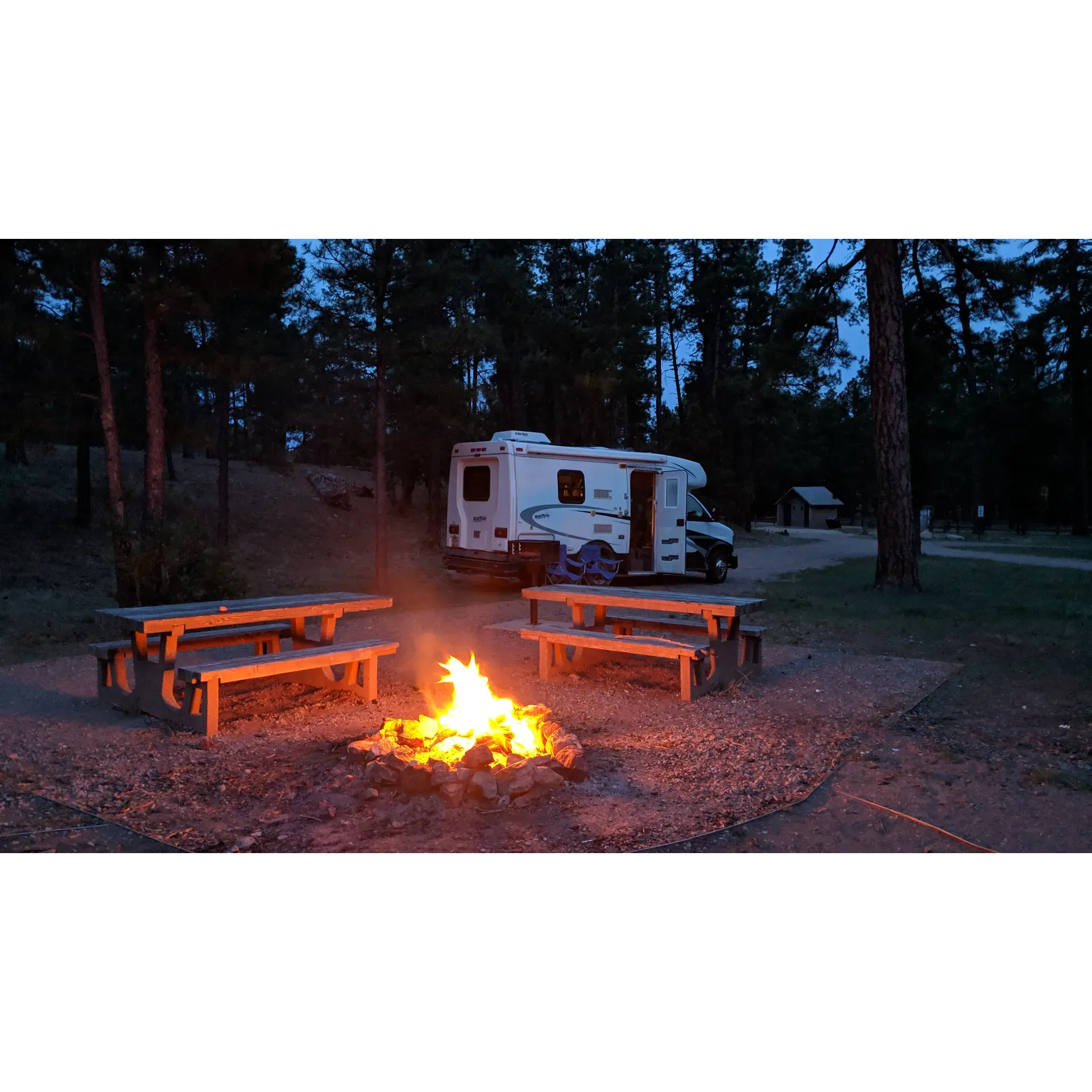 Discover the tranquil charm of Red Cloud Campground, a picturesque destination located just a short drive from the bustling city of Corona. With a limited number of camping spots available, this serene getaway offers a unique opportunity to enjoy the great outdoors without the crowds. Visitors are treated to awe-inspiring scenery, perfect for an array of activities including hiking and 4x4 adventures on trails that wind up to the mountain's summit, where breathtaking panoramic vistas await.

Embrace the natural beauty of this captivating area, home to abundant wildlife and roaming cattle in the surrounding landscape. The campground itself boasts well-maintained sites complete with deep fire pits featuring built-in grates for a hassle-free cooking experience, ensuring campers can savor the joy of outdoor meals even in damp conditions.

Though favored by hunters in the autumn season, Red Cloud Campground is a delightful stop for travelers at any time of the year, offering seclusion and relaxation among lush trees and impeccable views. Facilities such as clean vault toilets, convenient trash cans, and robust toilets are available to enhance your stay, ensuring the environment remains pristine for all to enjoy.

Accessibility is effortless with roads leading to the campground being exceptionally well maintained. Whether you're seeking a peaceful retreat or a brief respite during a road trip, Red Cloud Campyard is an idyllic spot not far from major highways. Along the approach, the rustic charm unfolds as you encounter gentle curves demarcating your path, with the occasional local landowner out for a horse ride — a gentle reminder to share the countryside responsibly.

In this secluded paradise, the soundtrack to your escape is the whispering of trees and the quiet hum of nature itself — a perfect setting for those looking to unwind, rejuvenate, and reconnect with the wilderness. So, if your travels take you through the great outdoors, consider a stop at Red Cloud Campground; it promises a memorable and restful experience amidst the beauty of nature. Description by ChatGPT.